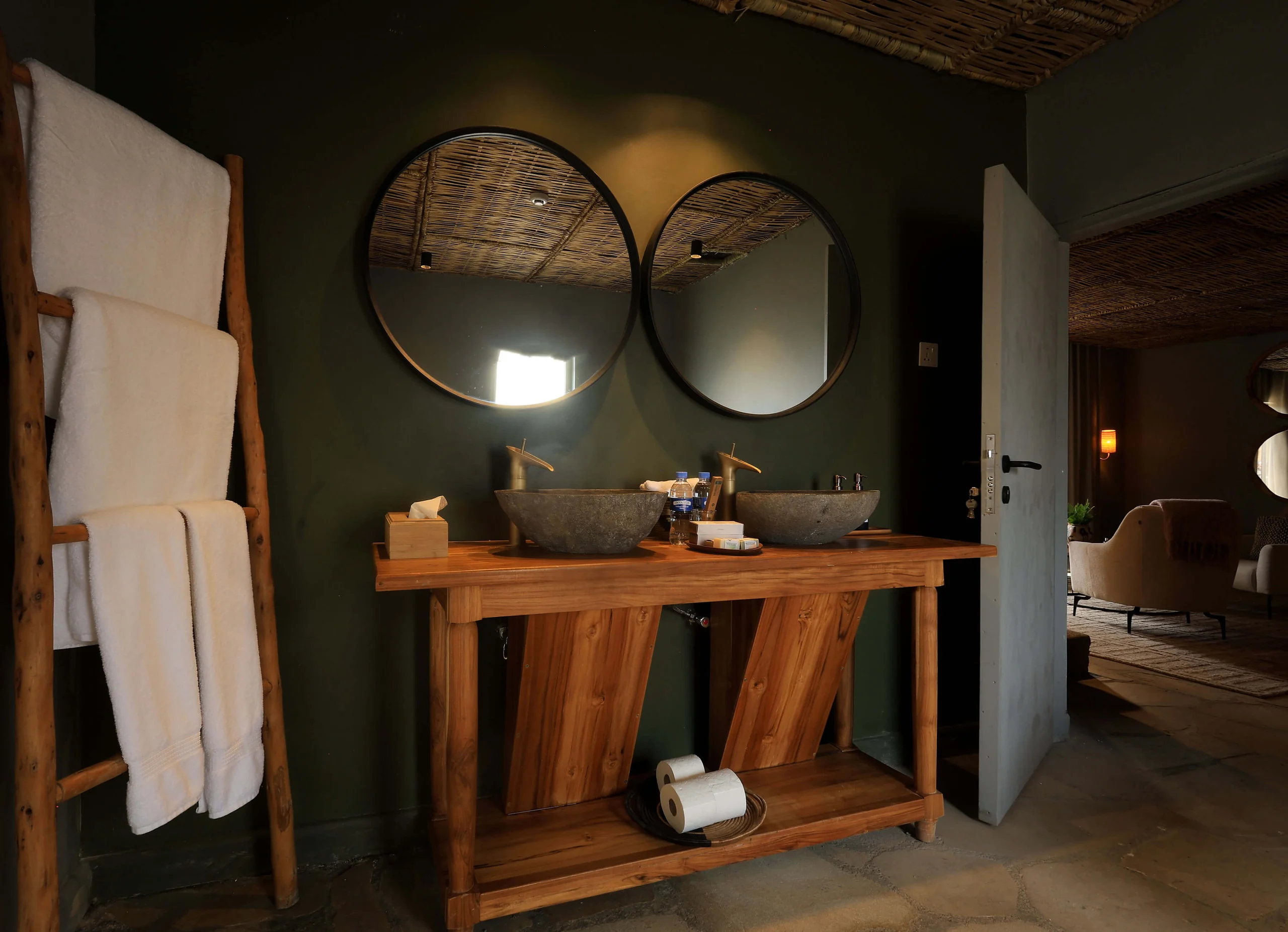 A bathroom with twin basins and round mirrors