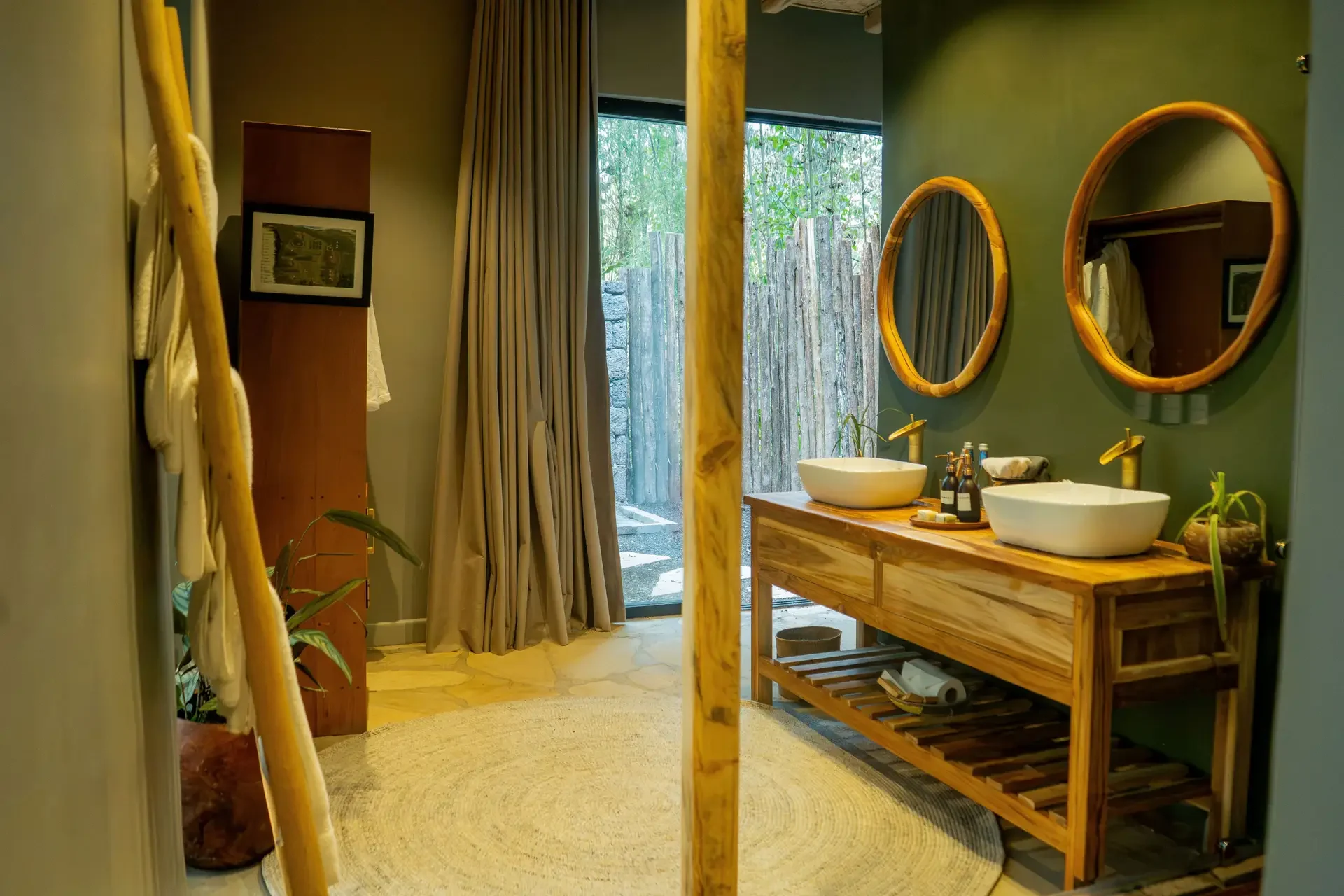 A bathroom with timber basins and a window onto the garden