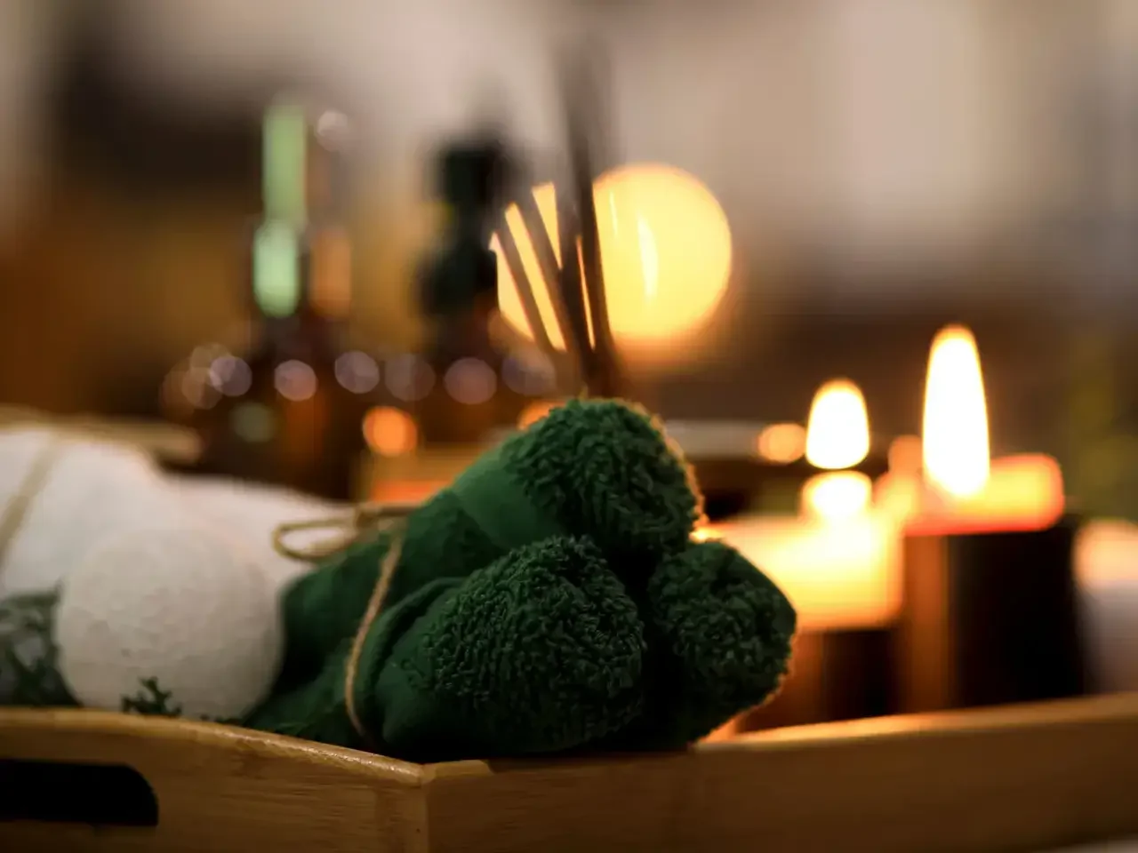 Rolled towels beside candles in the spa