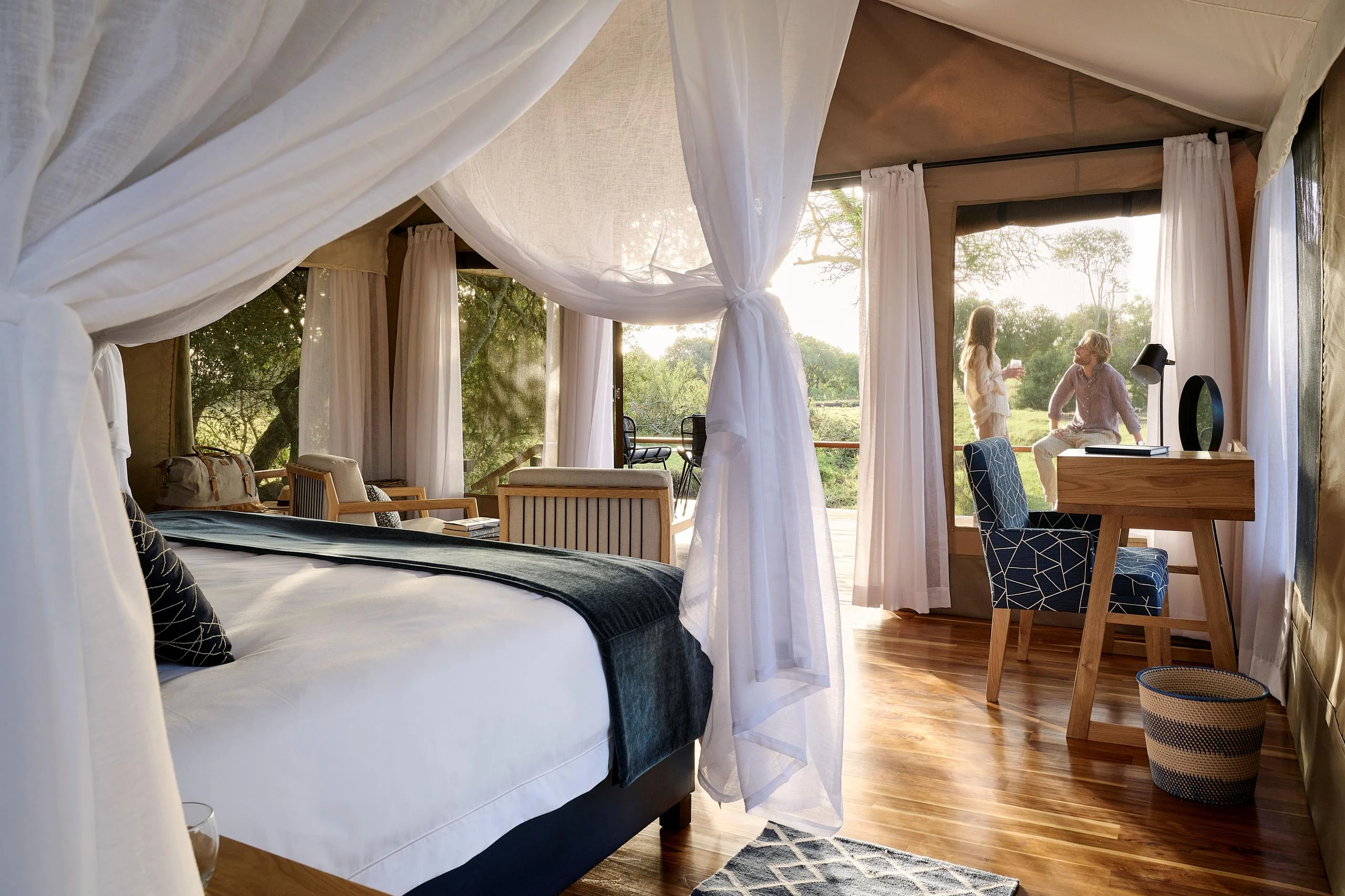 A tent bedroom with a canopied bed