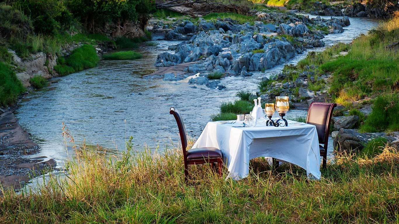 A table laid beside the river