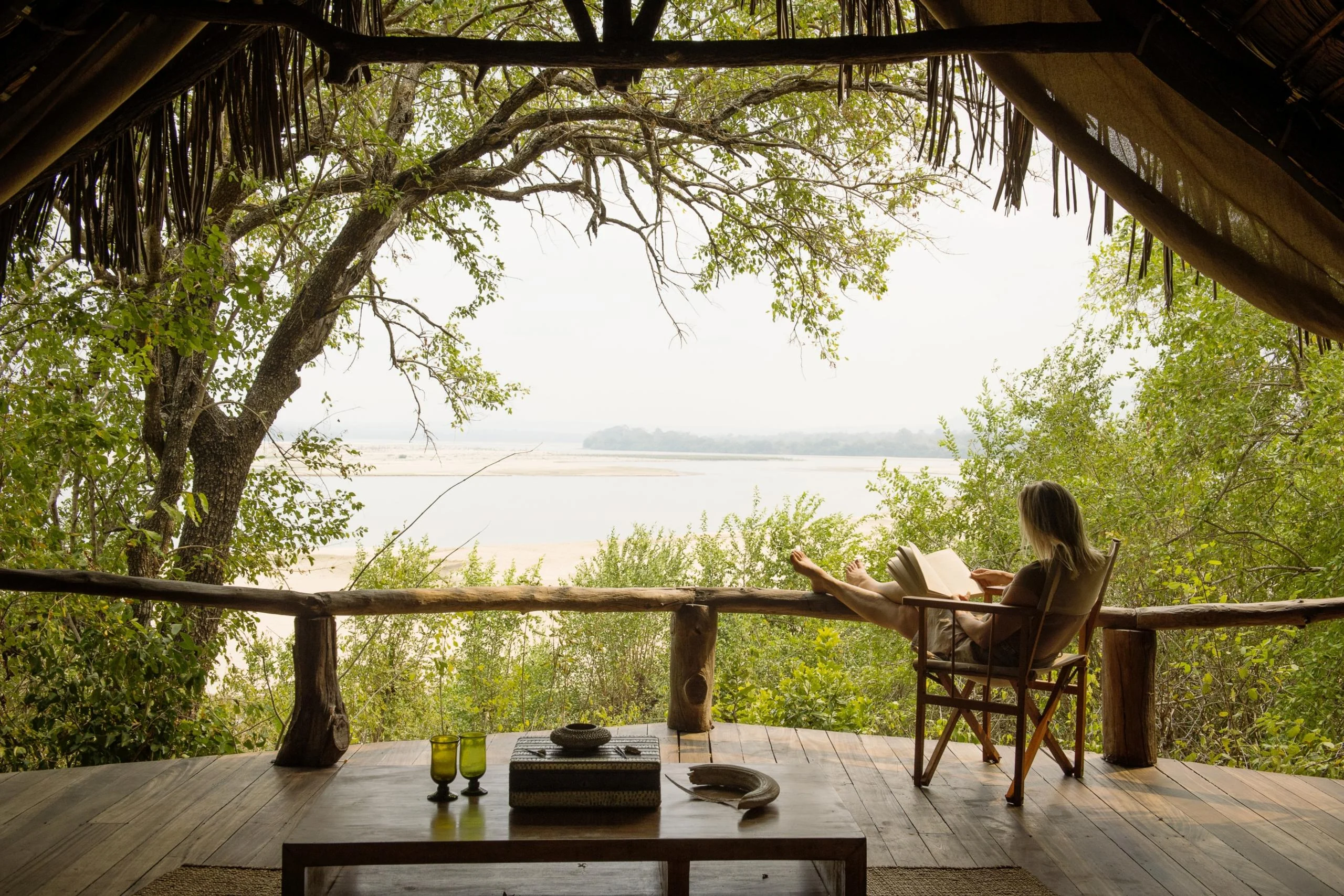 A guest on the deck of a room above the river