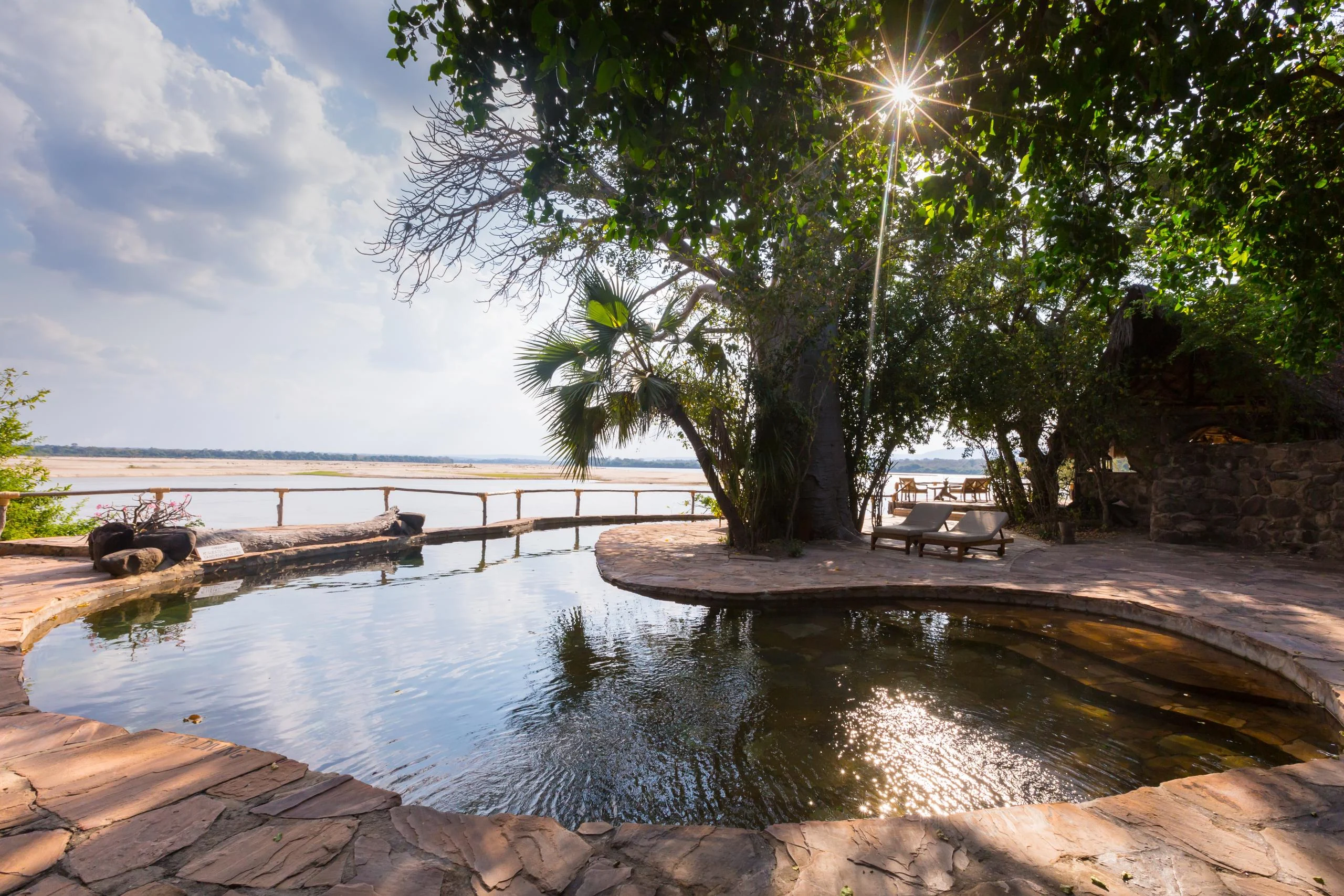 The pool beneath the trees beside the river