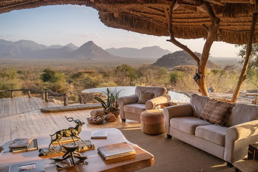 The lounge under thatch with the hills beyond