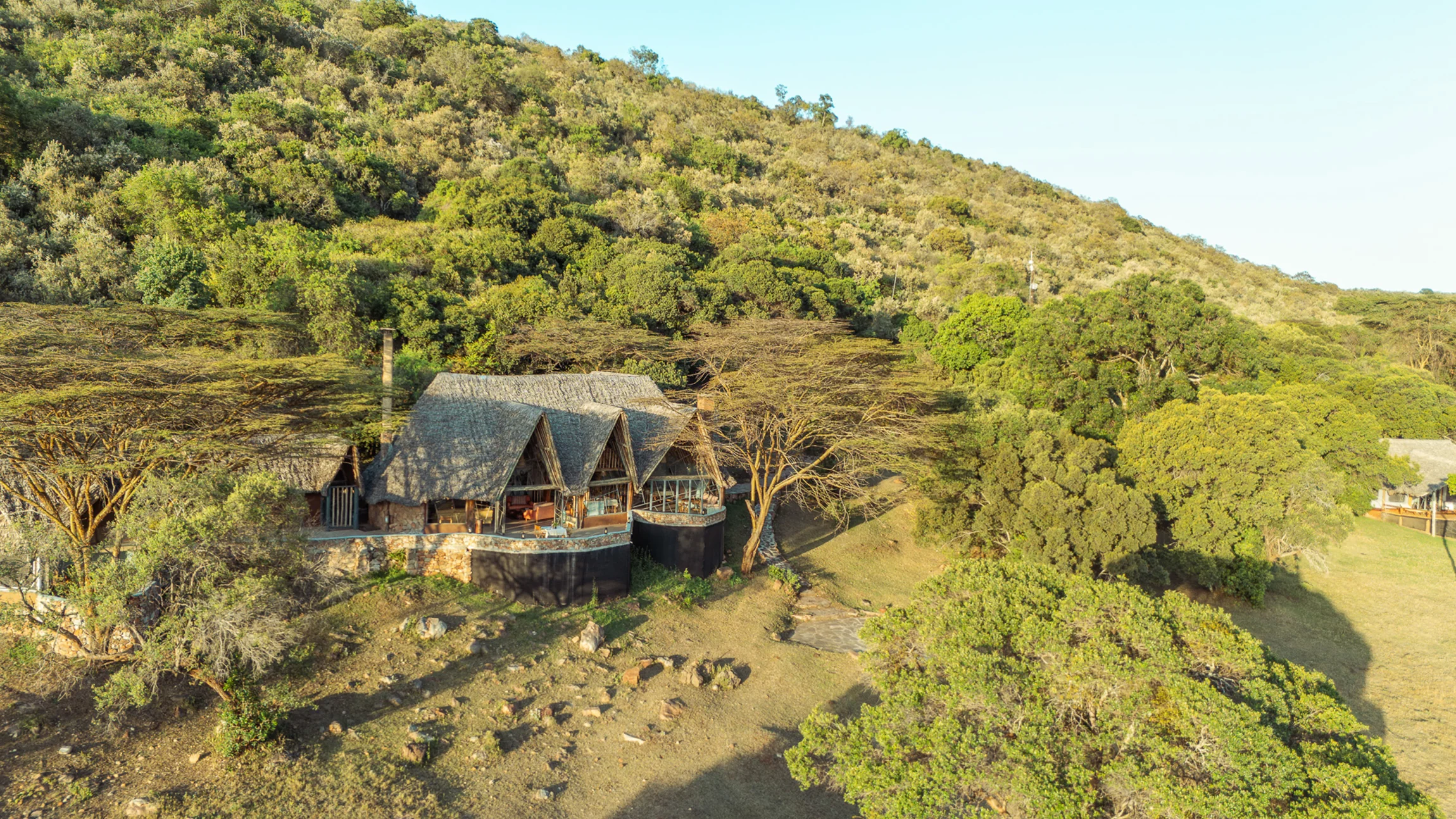 The lodge in its wooded valley, from the air