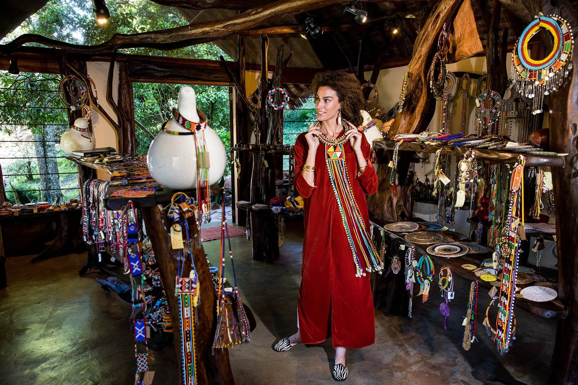 A guest browsing beadwork in the camp shop