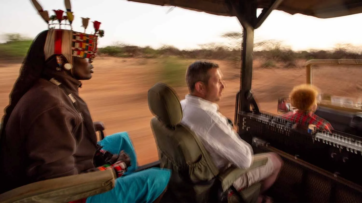 A Samburu guide and guests on a game drive