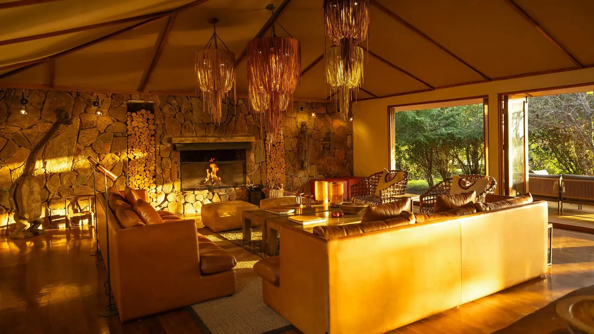 The lounge with a stone fireplace and hanging lamps