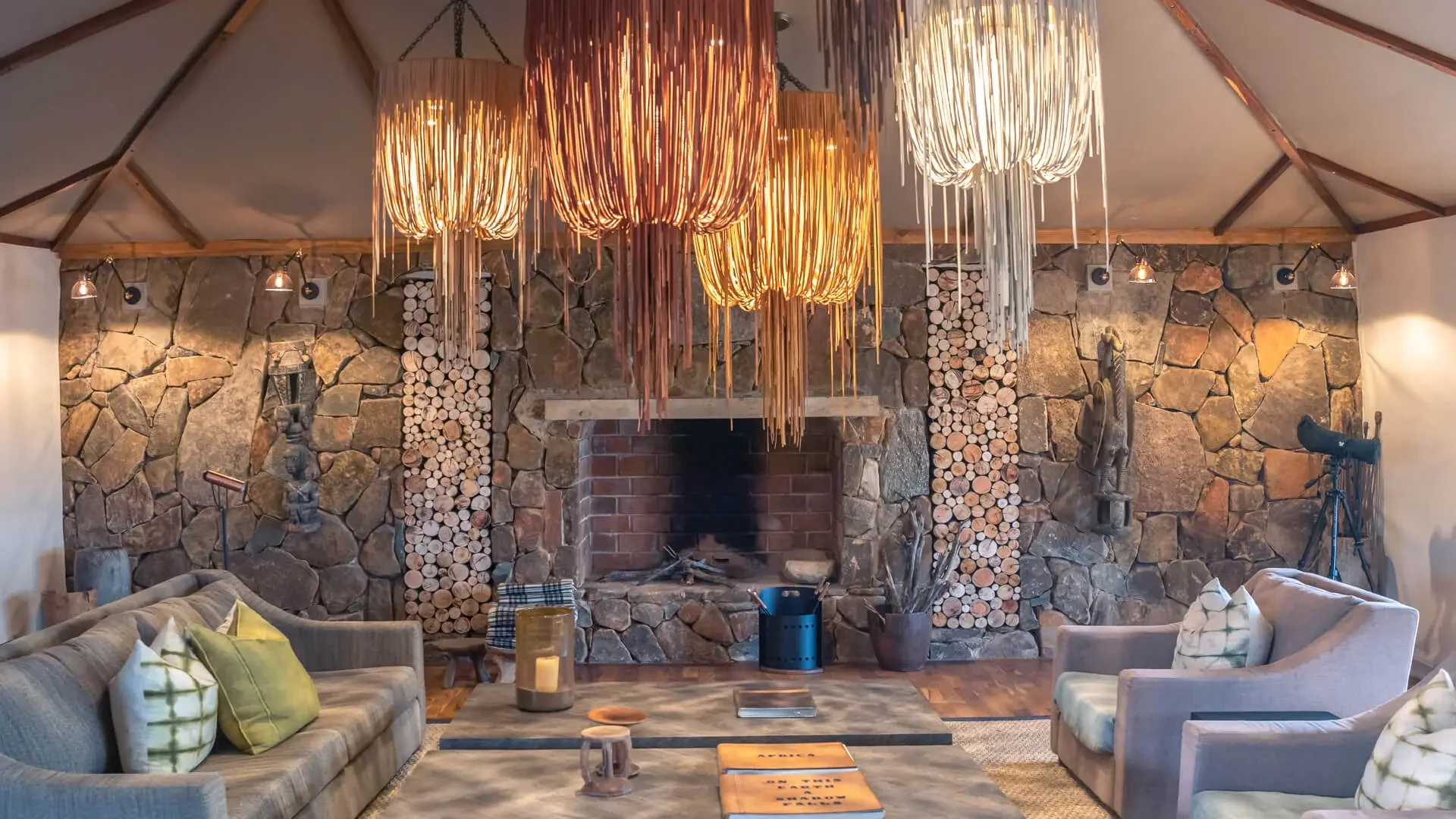The lounge with a fireplace and grey armchairs