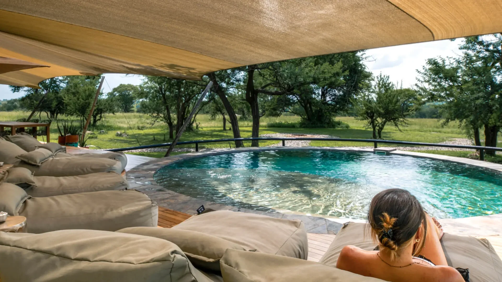 A guest at the edge of the plunge pool, looking over the plains