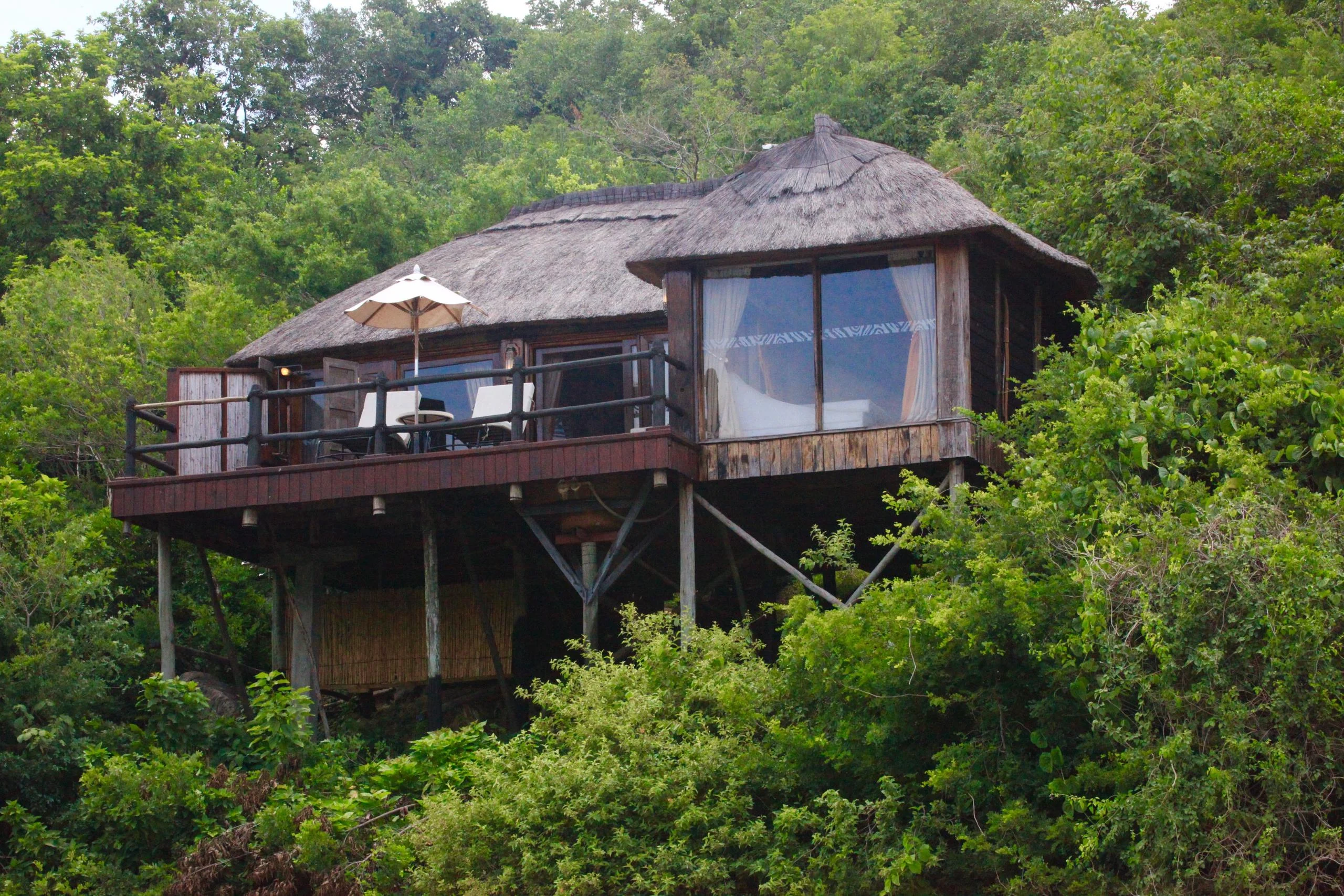 A thatched room on stilts above the river