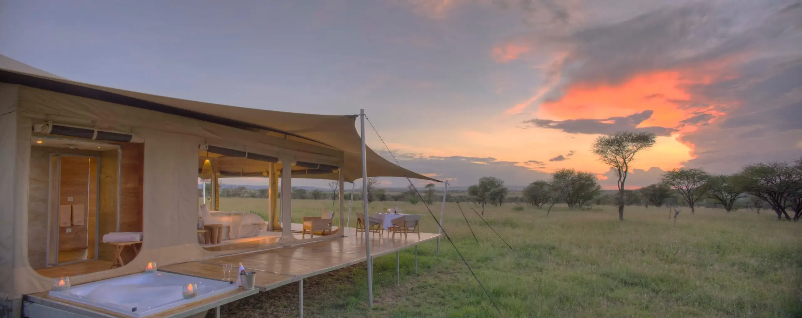 A guest tent with its deck at sunset