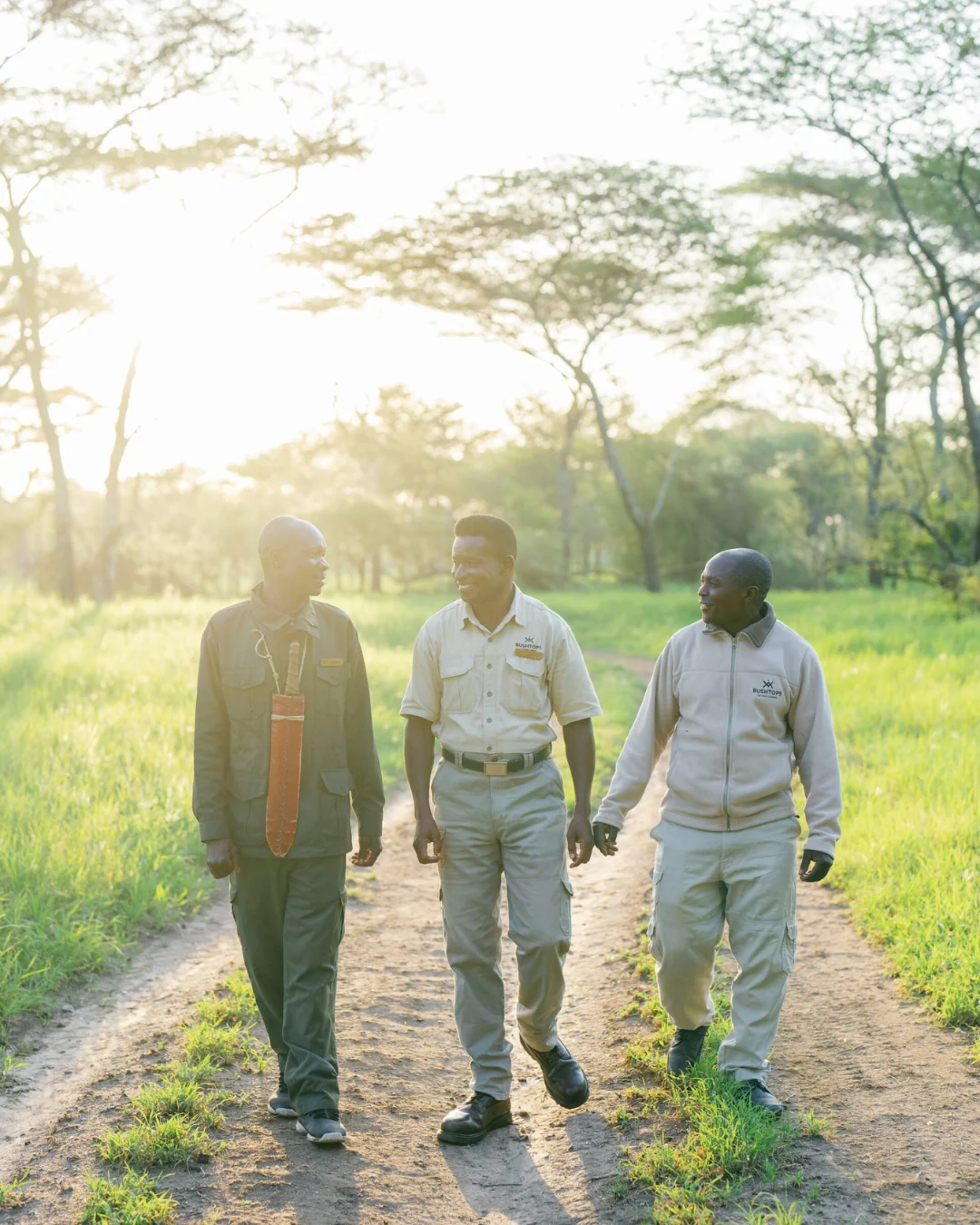 Three members of staff walking along a track
