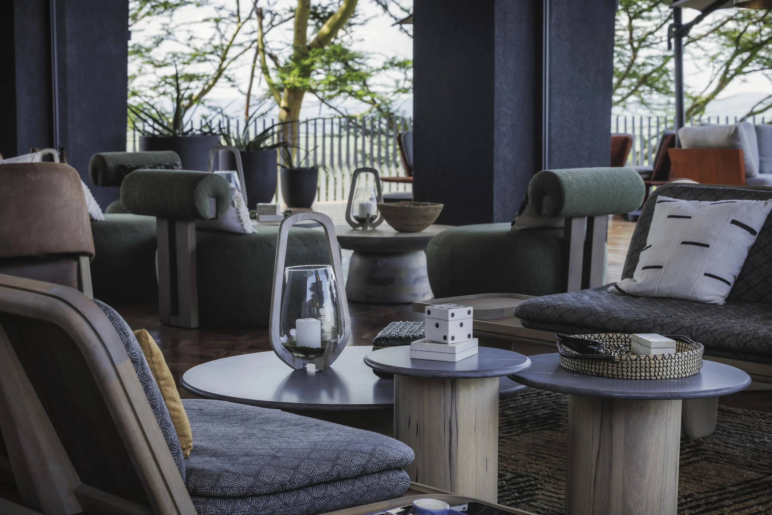 A sitting area with armchairs and the trees beyond