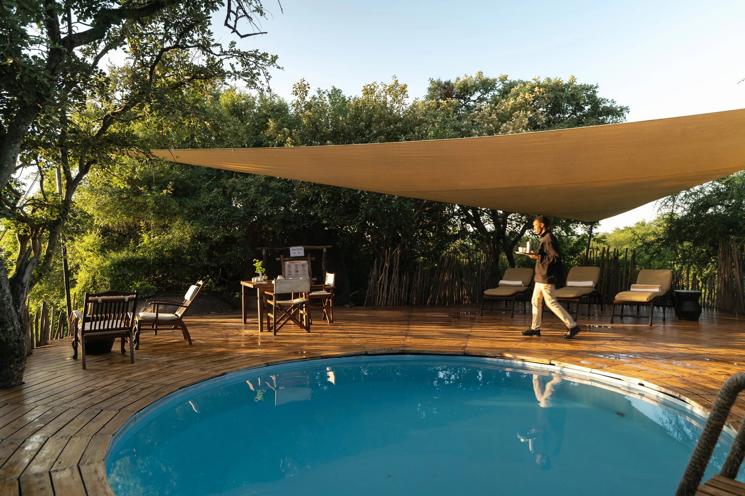 The swimming pool and shaded terrace at Serengeti Pioneer Camp