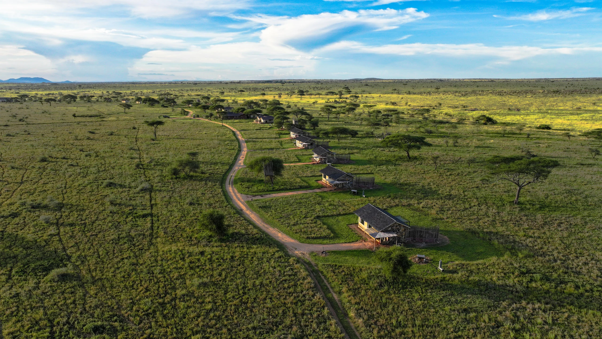 The camp's rooms and road across the plains, from the air