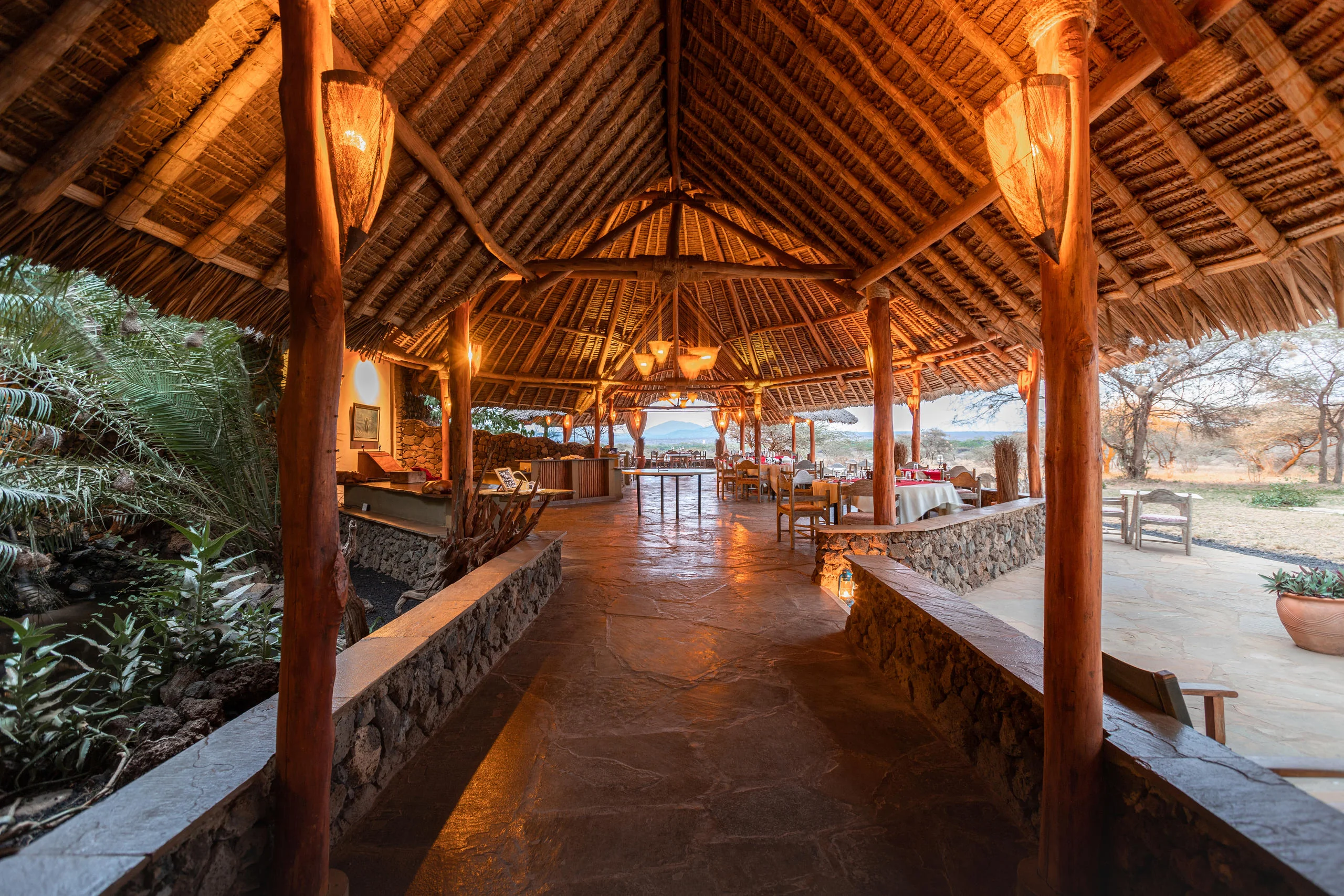 The main building under thatch with a stone floor