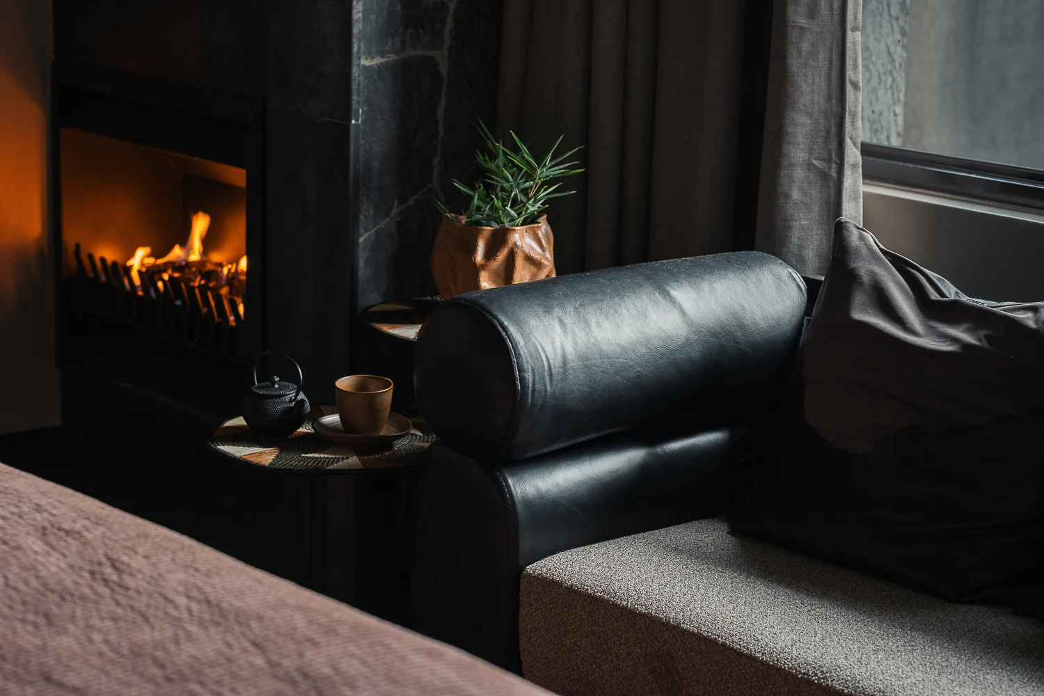 An armchair beside the fireplace in a room
