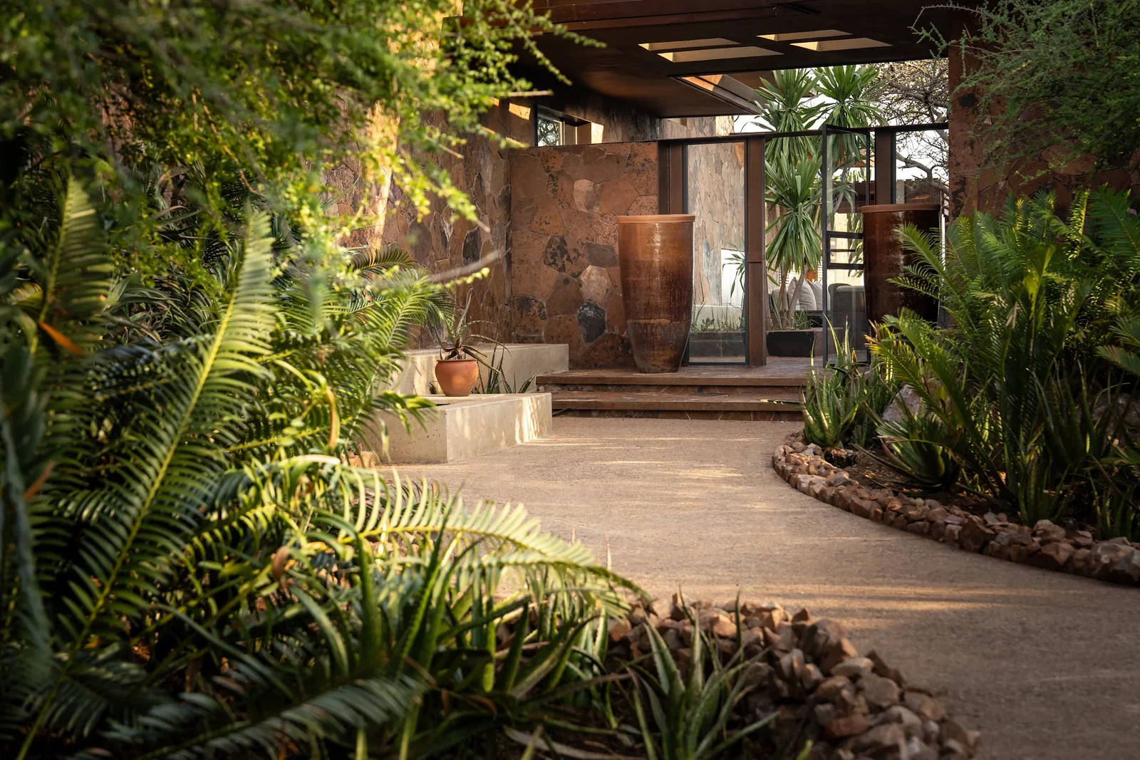 The shaded entrance walkway at Singita Kilima