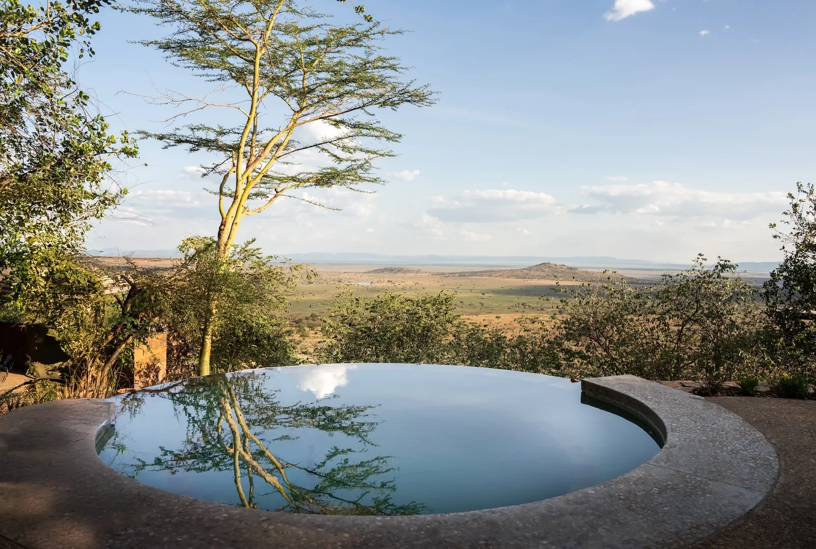 A circular pool overlooking the plains at Singita Kilima