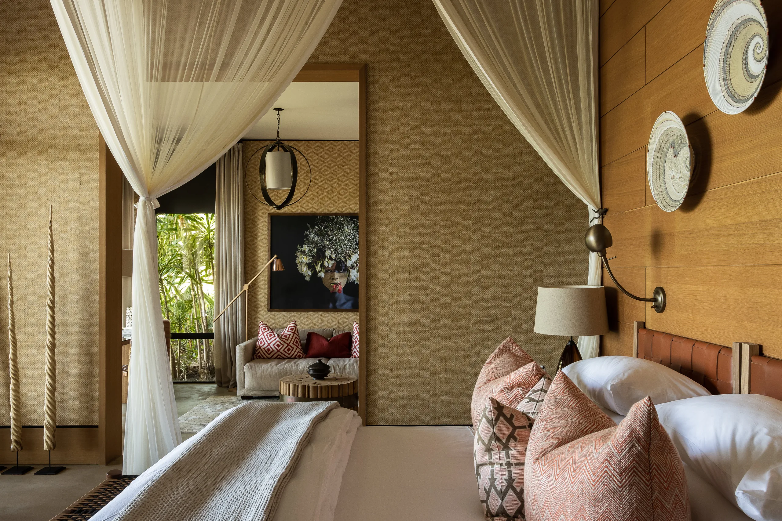 A canopied bed and soft furnishings in a junior suite at Singita Kilima