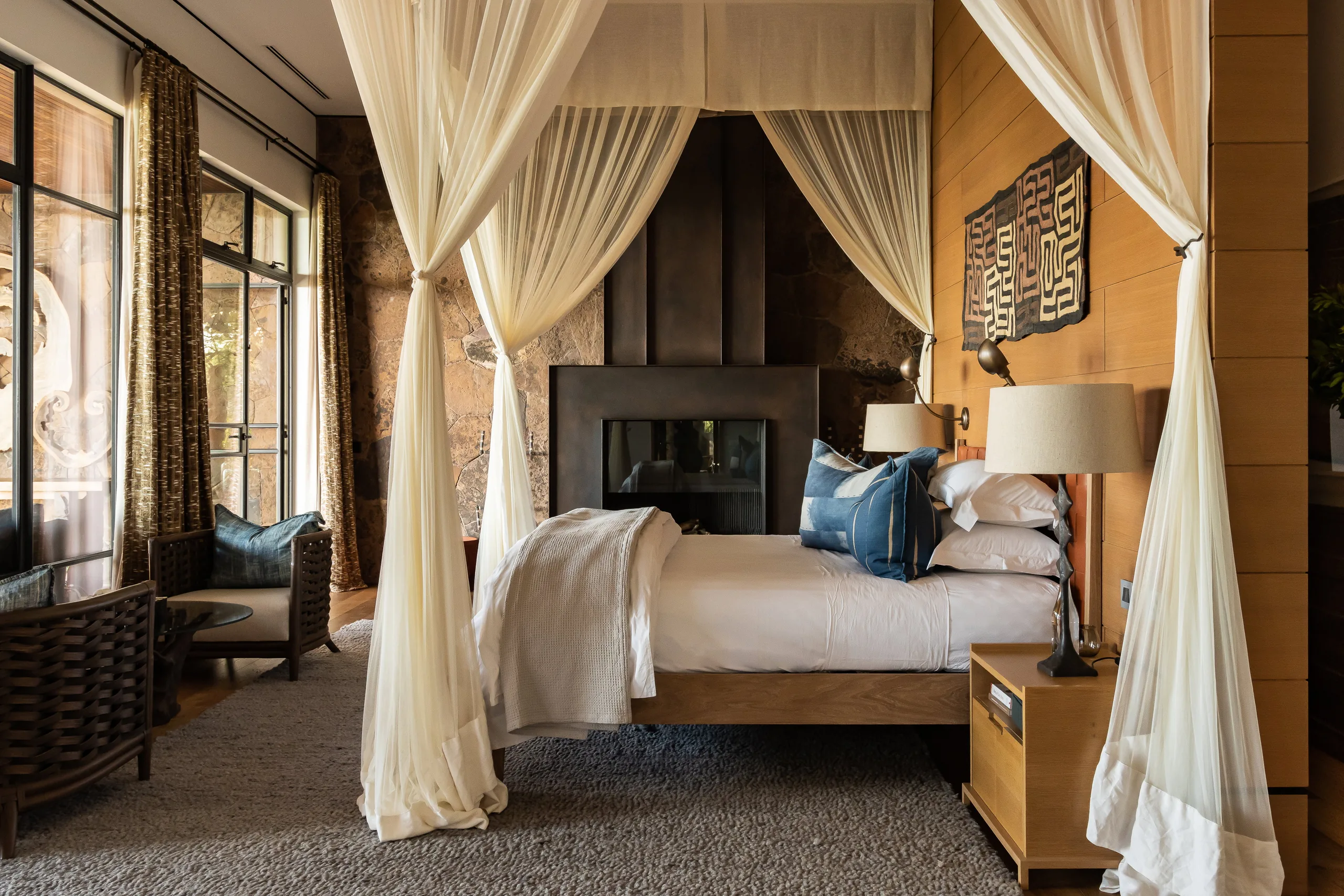The canopied bed and seating in the main suite at Singita Kilima