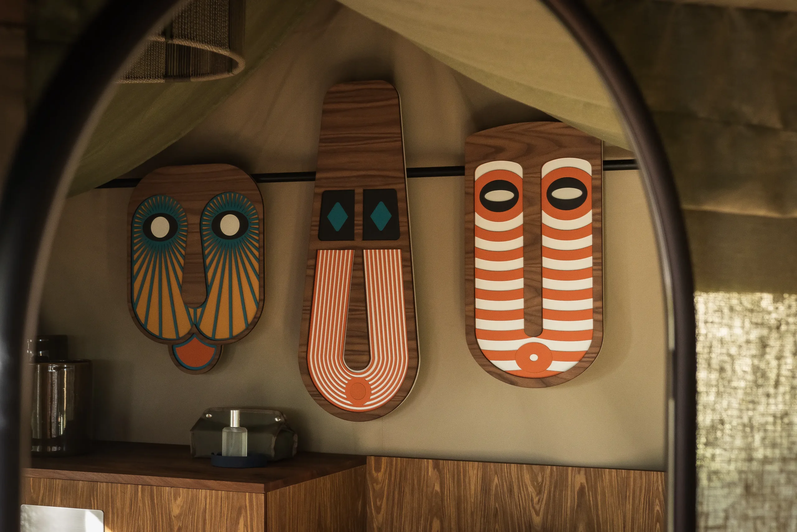 Painted masks on the wall of a tent