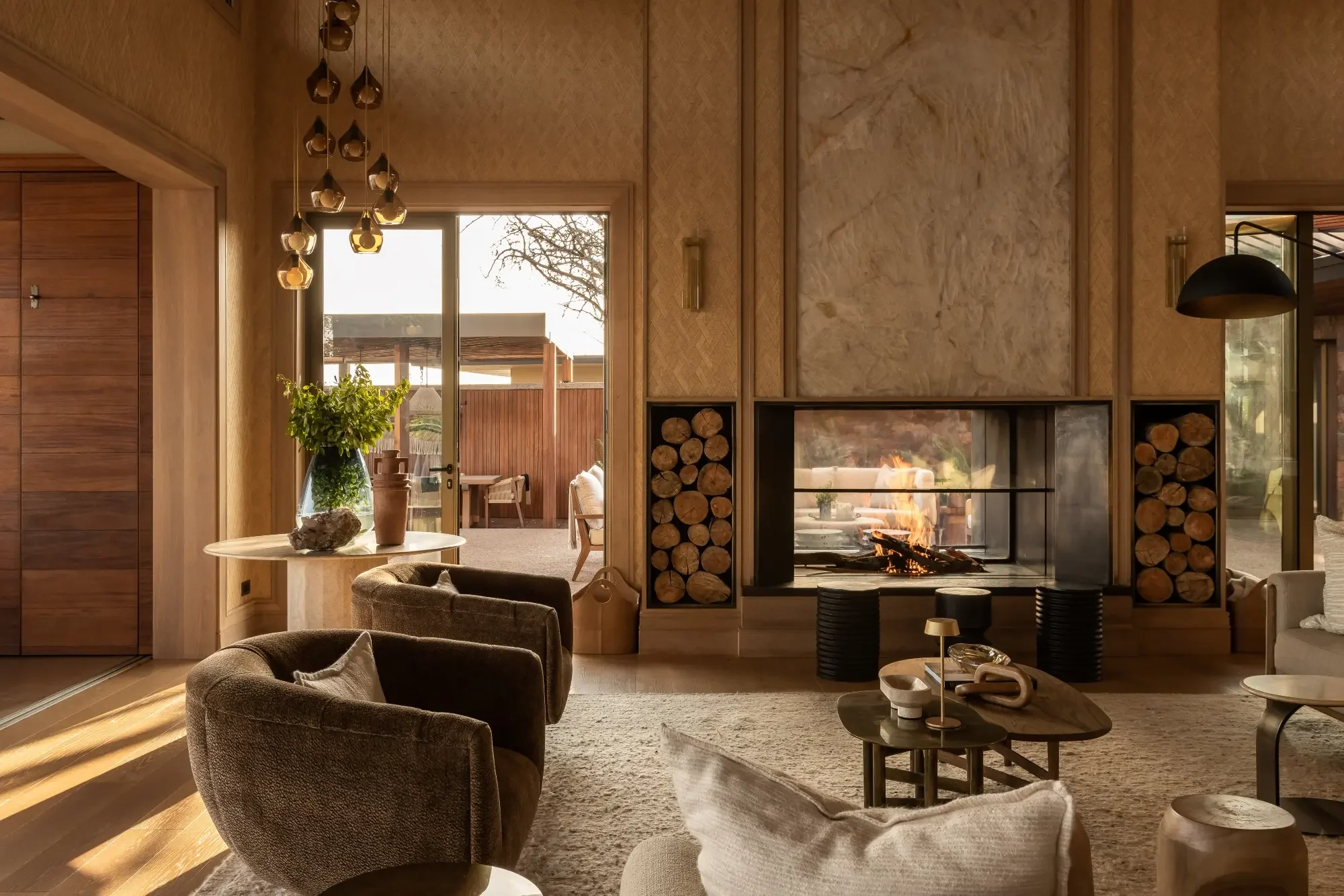The sitting room with a fireplace and velvet armchairs