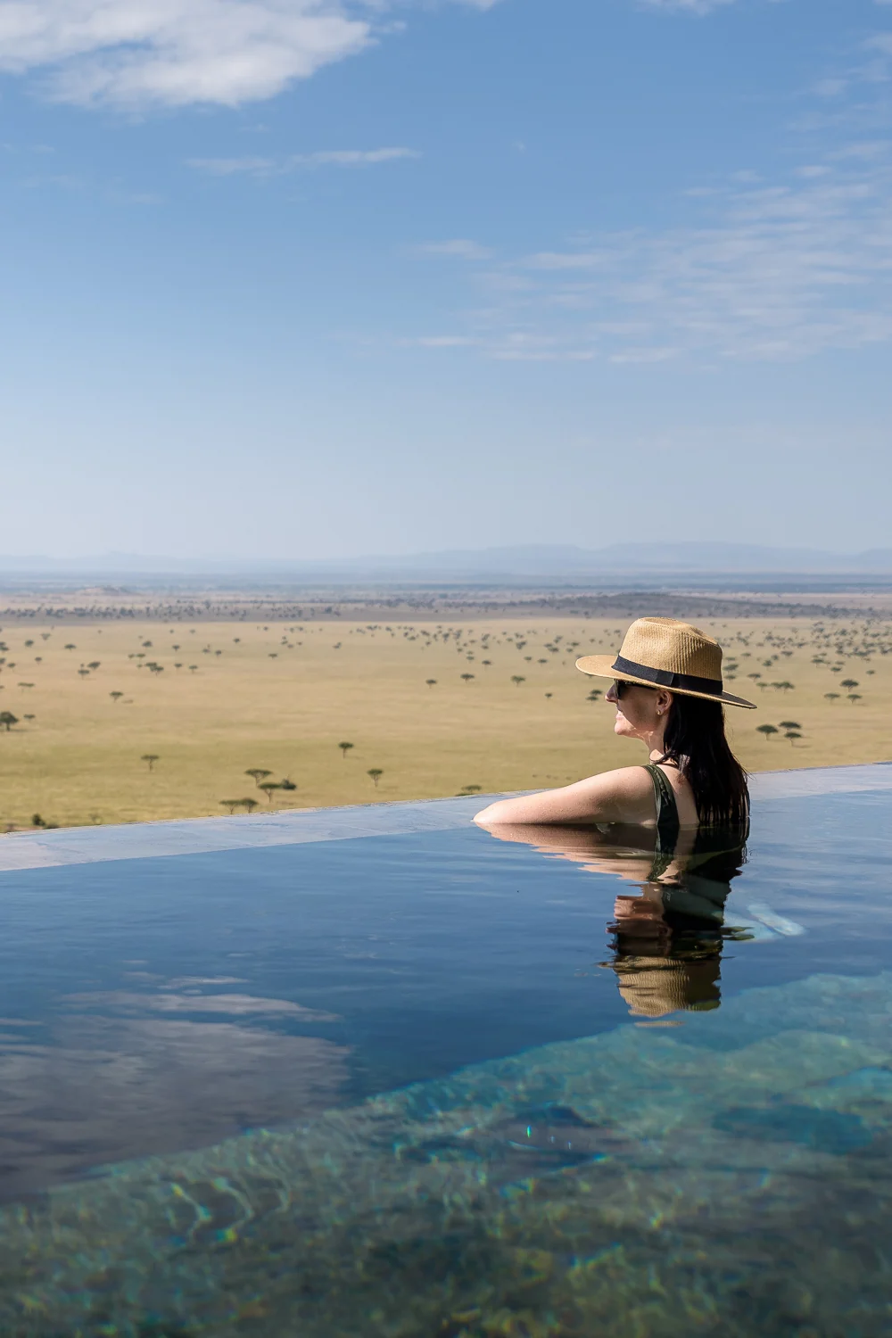 A guest in the pool, looking over the plains