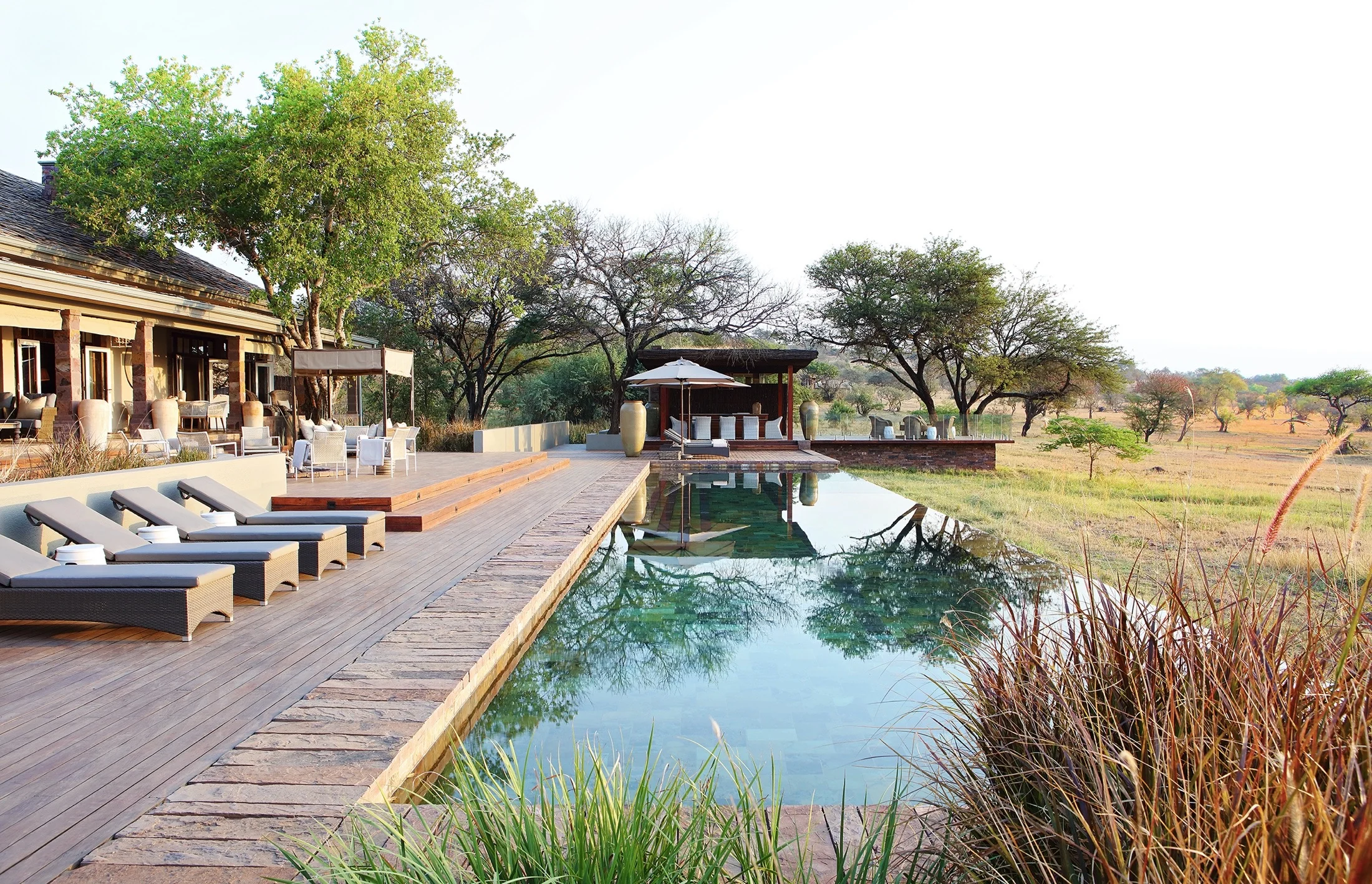 The house and its pool with the plains beyond