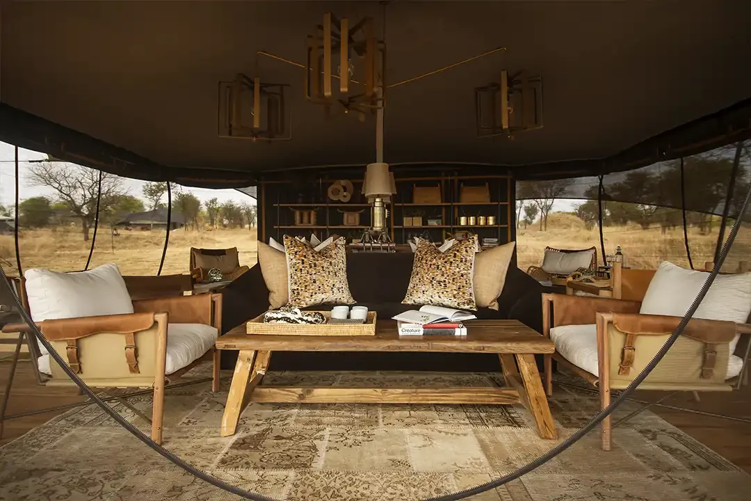 The lounge tent with a timber table and cushions