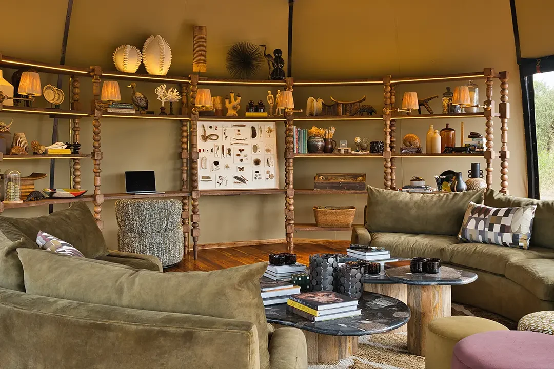 The lounge with a sofa and a shelved cabinet of curios