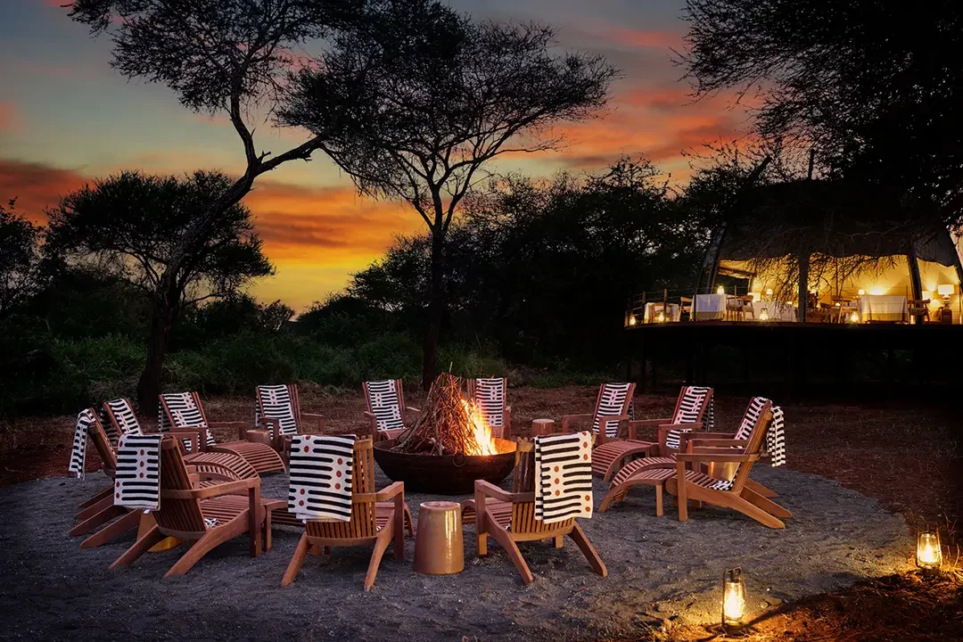 Chairs around the campfire at sunset