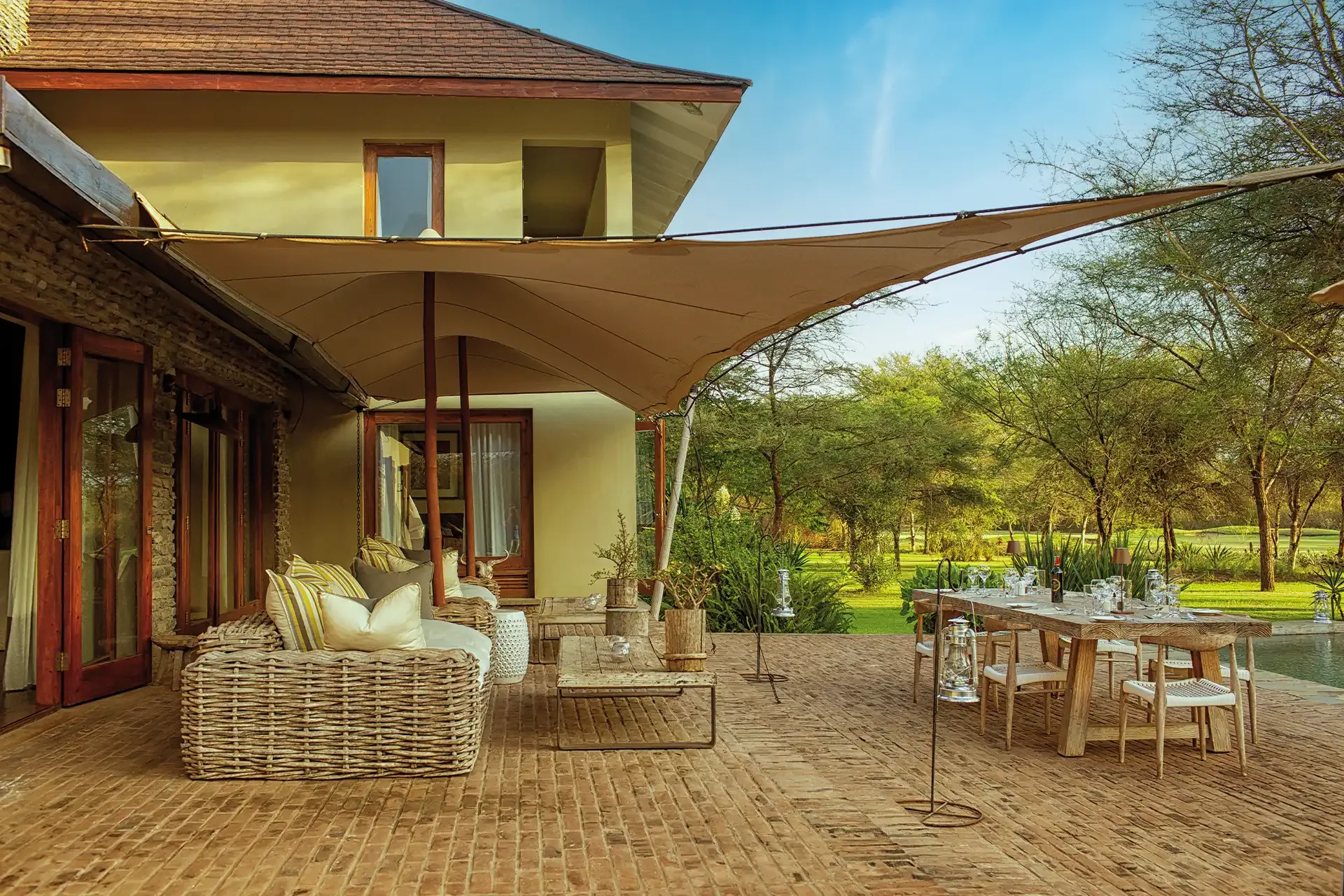 The villa terrace with its sofas and shaded dining table