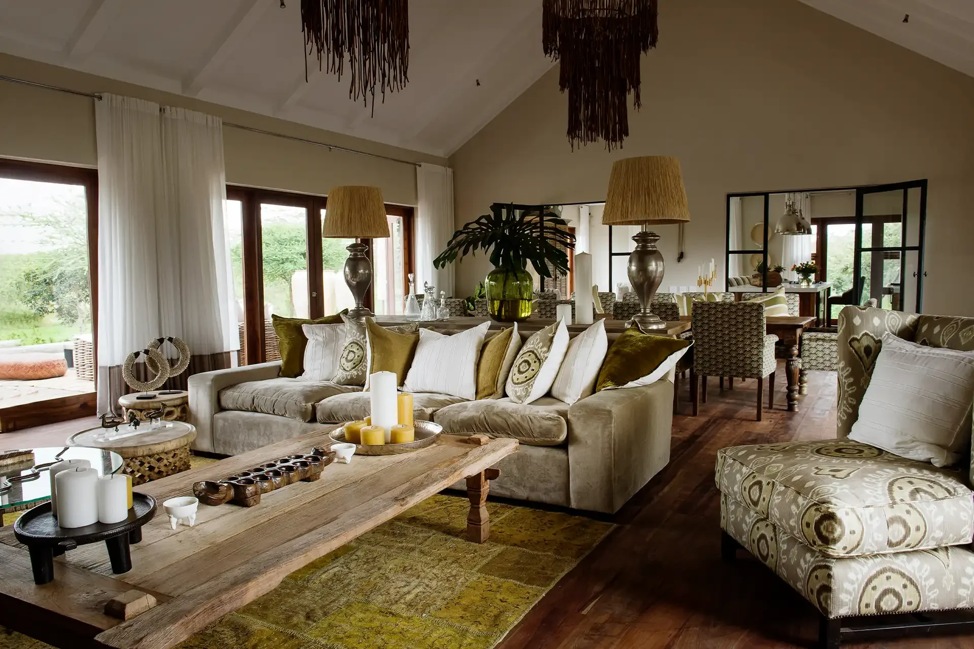 The sitting room with pale sofas and a high ceiling