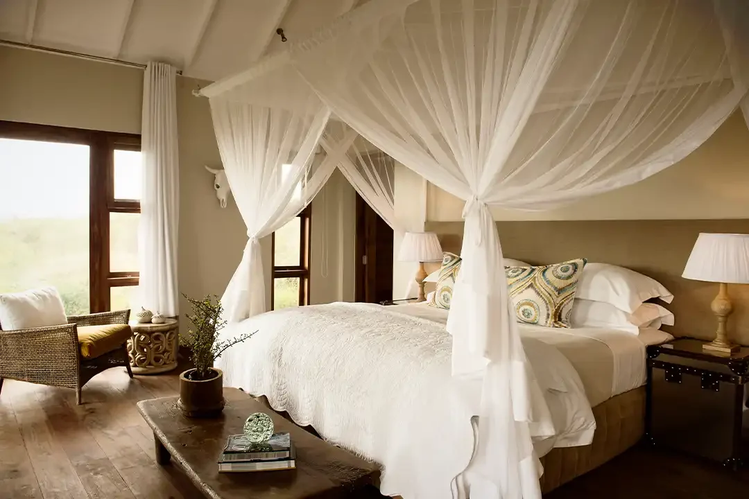 A bedroom with a draped four-poster bed