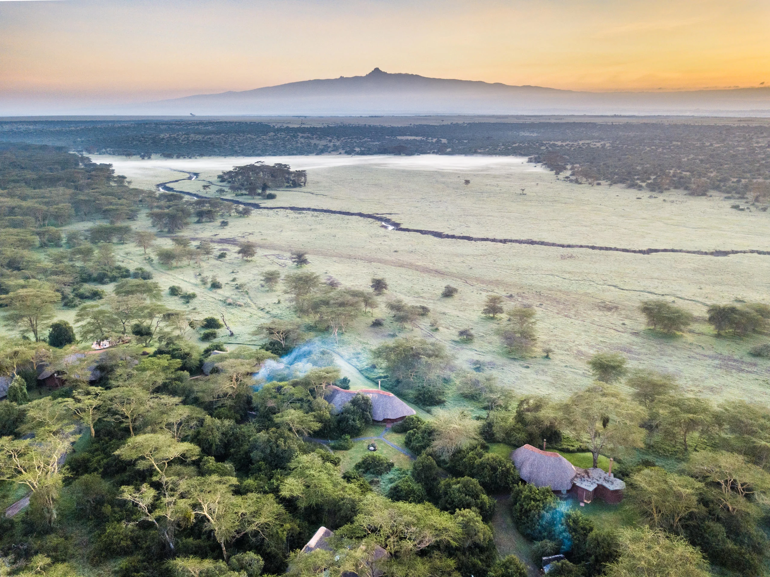 The lodge on the plains at sunrise with Mount Kenya beyond, from the air