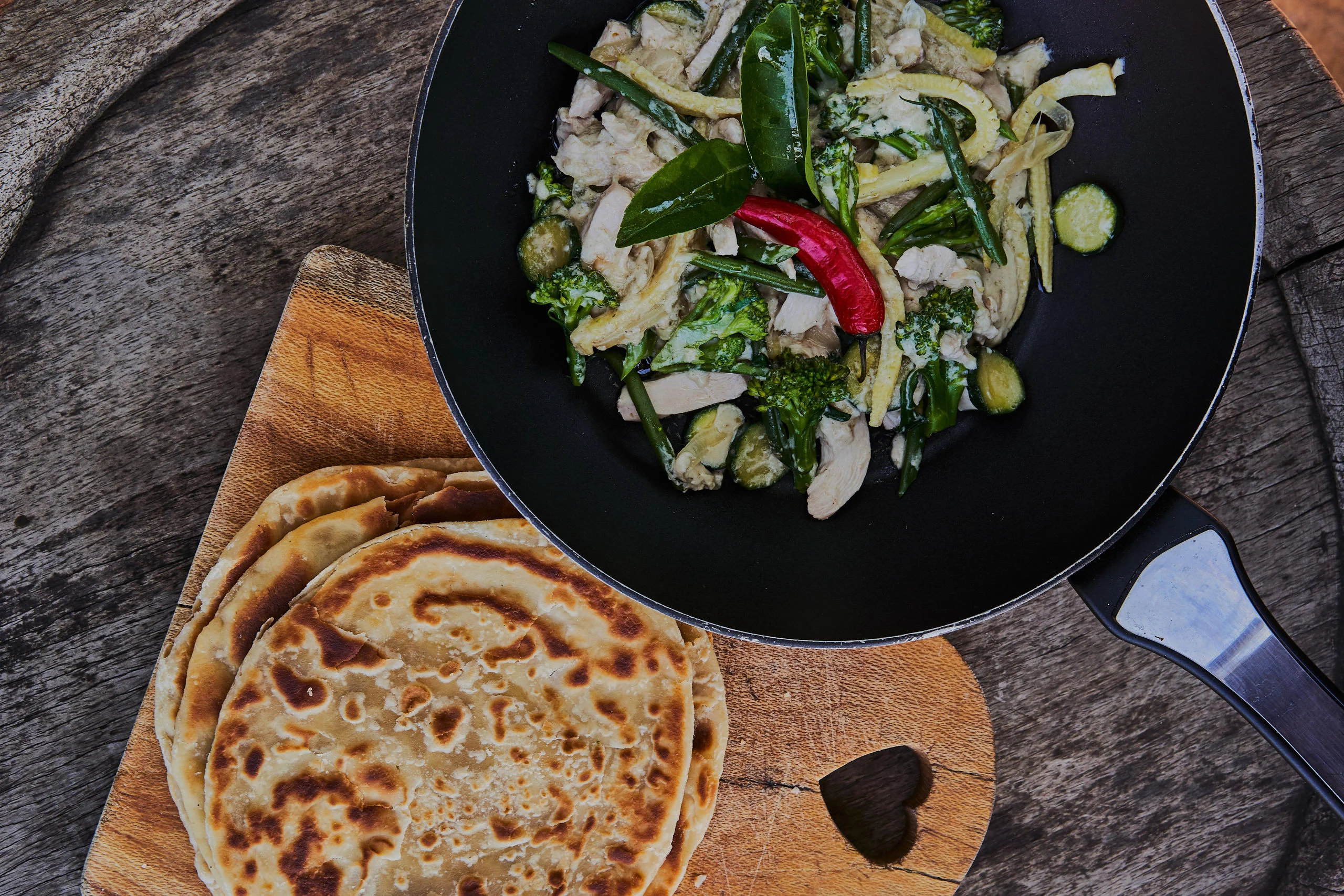 A pan of salad with flatbreads