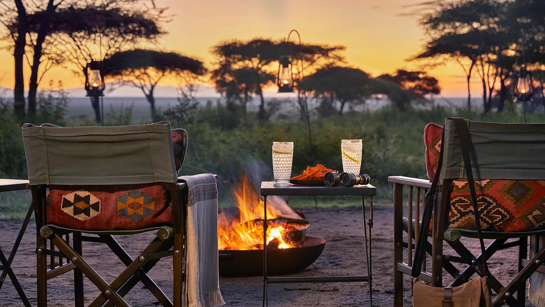 Chairs around the campfire at sunset