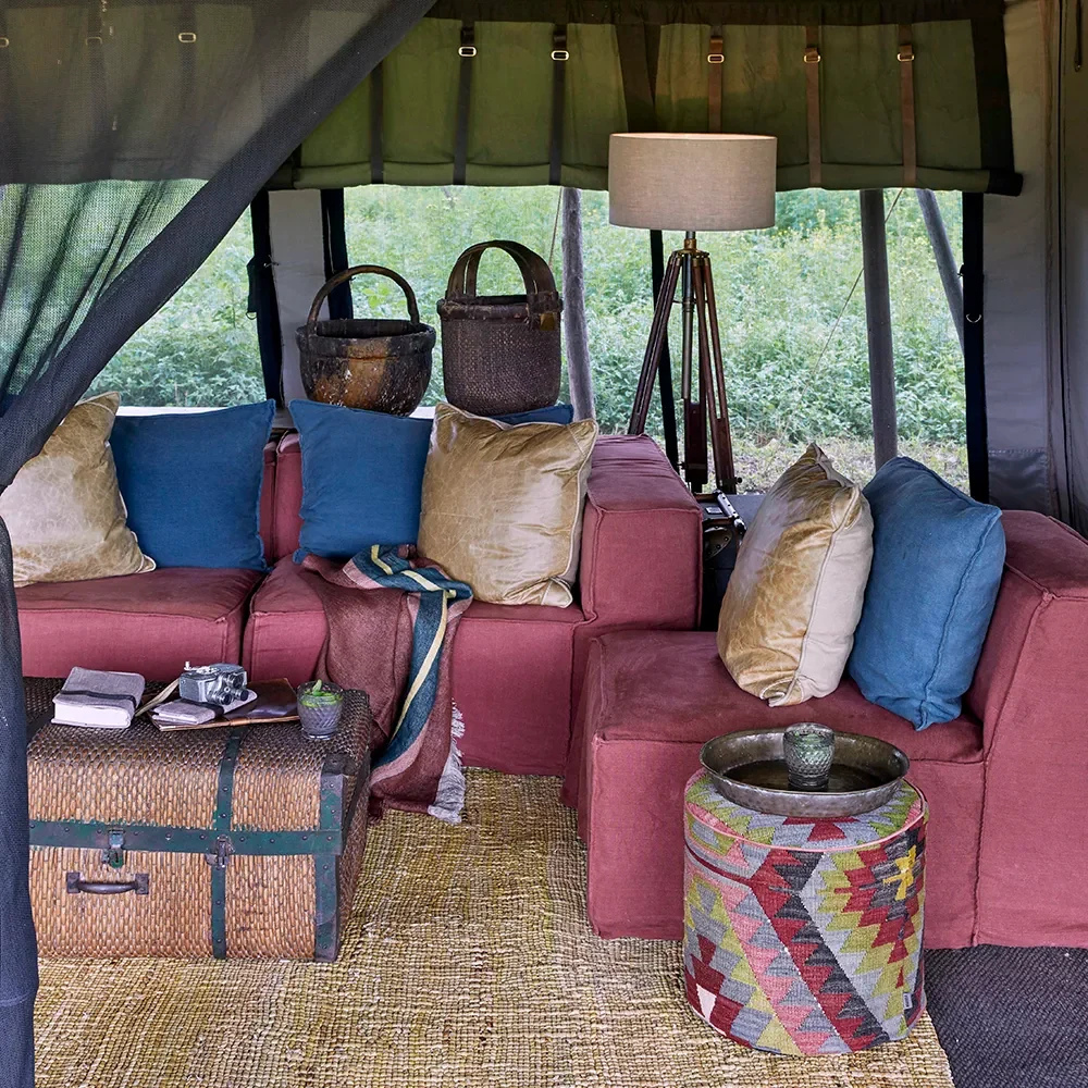 The lounge tent with a red sofa and patterned cushions