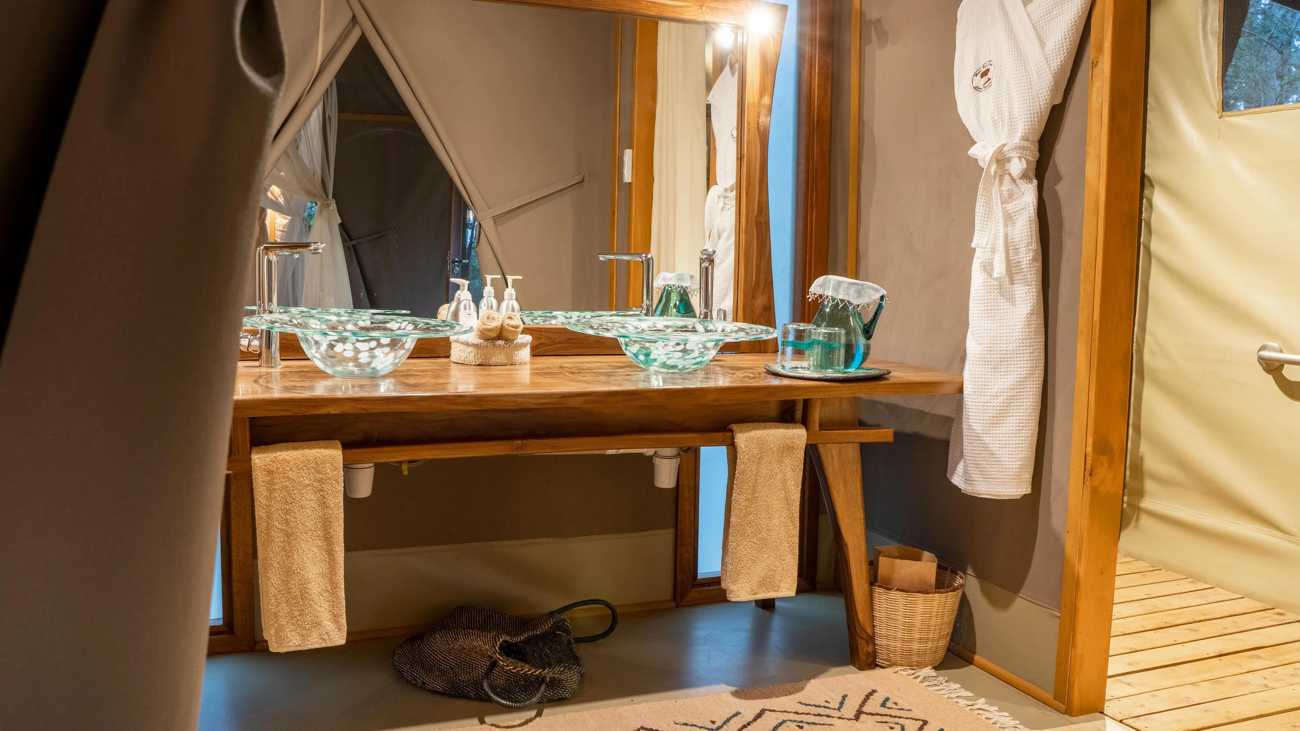 A tent bathroom with twin basins