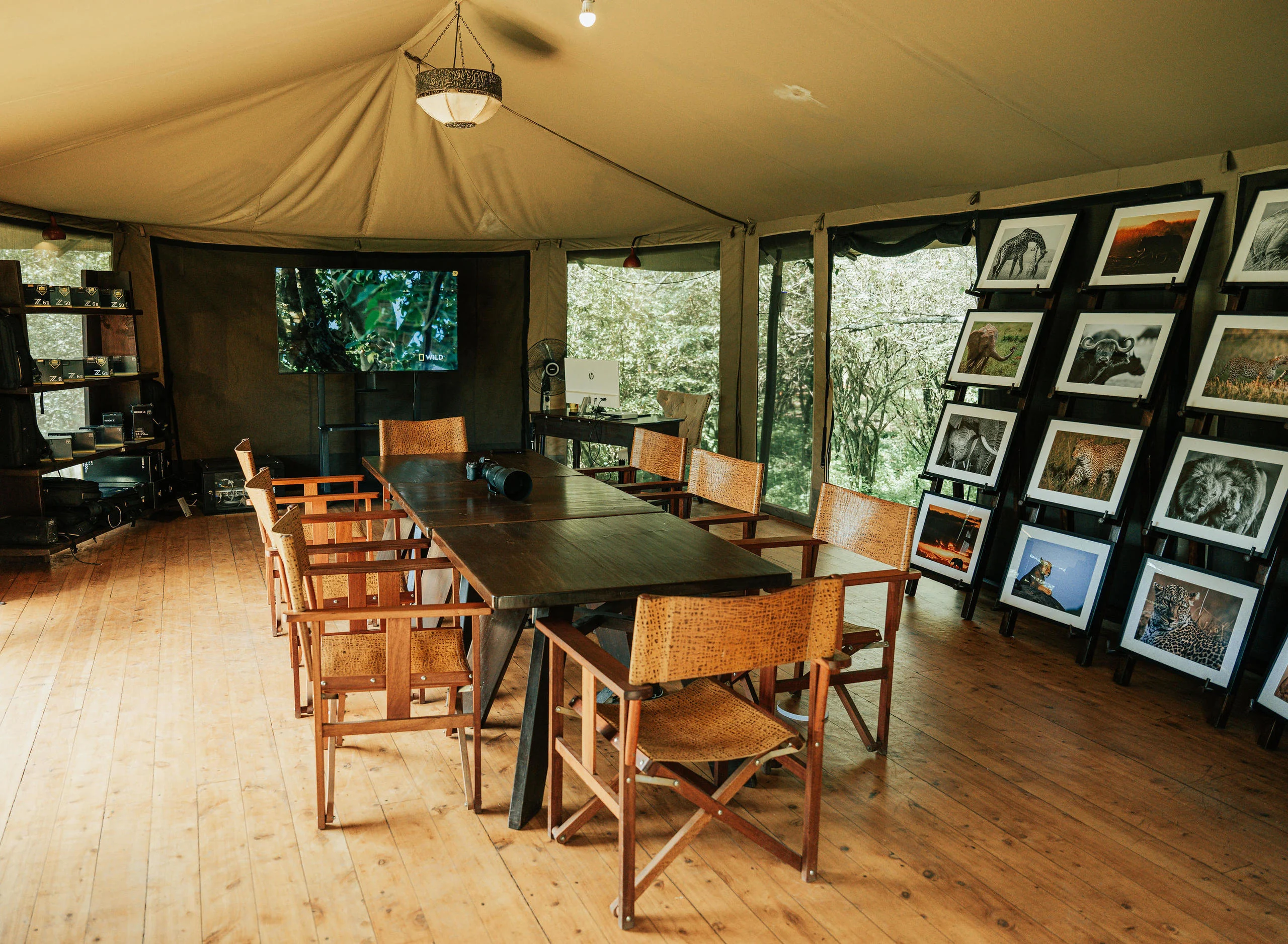 The dining tent with a wall of framed photographs