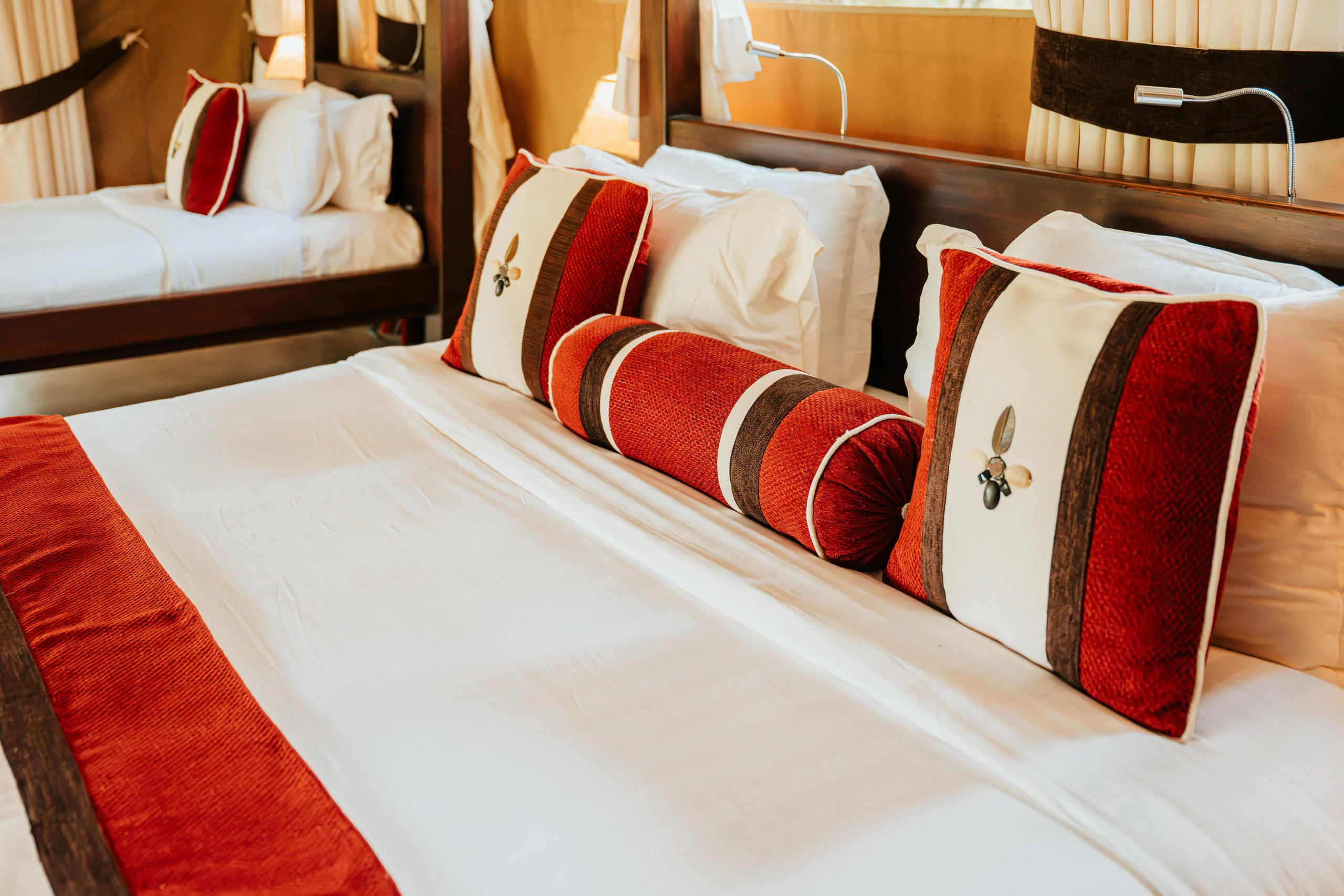 A bed with red and white cushions