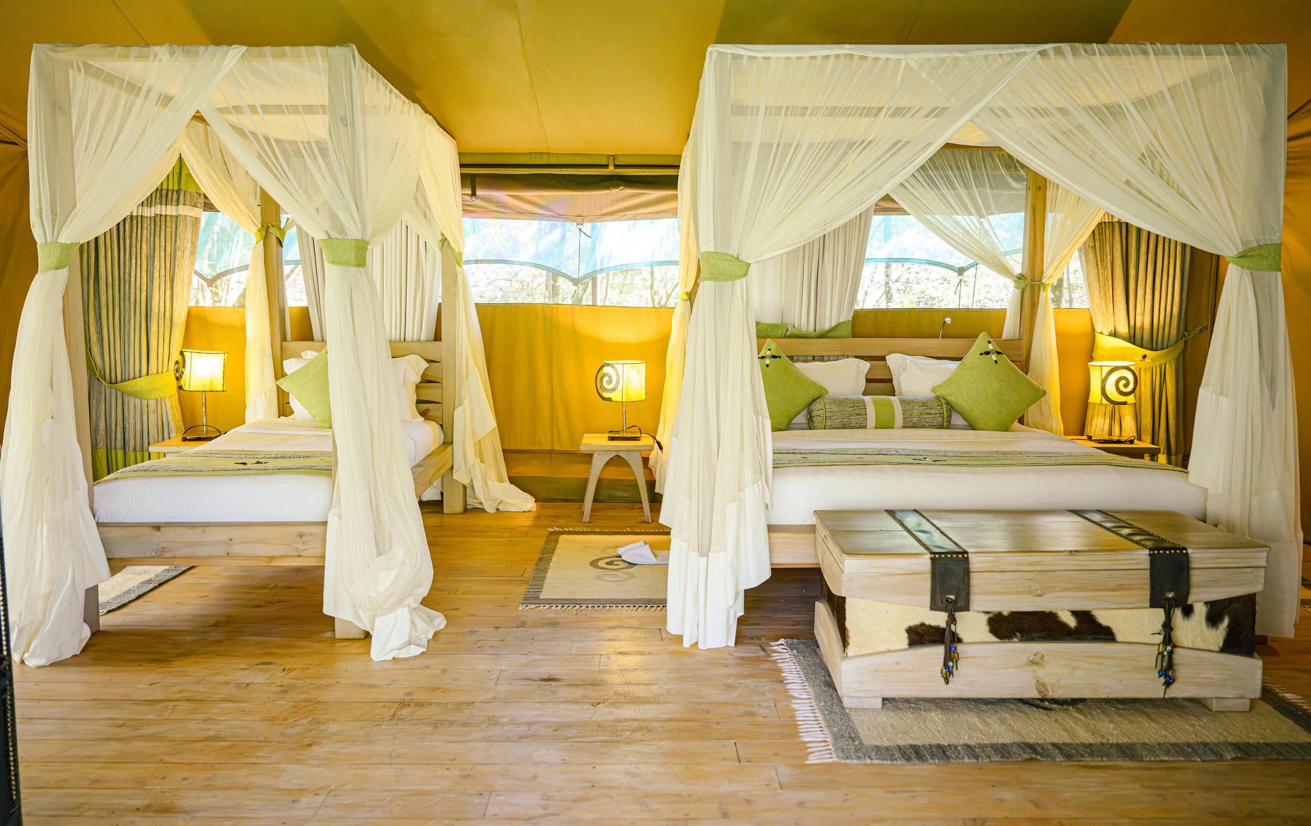A tent with twin draped beds