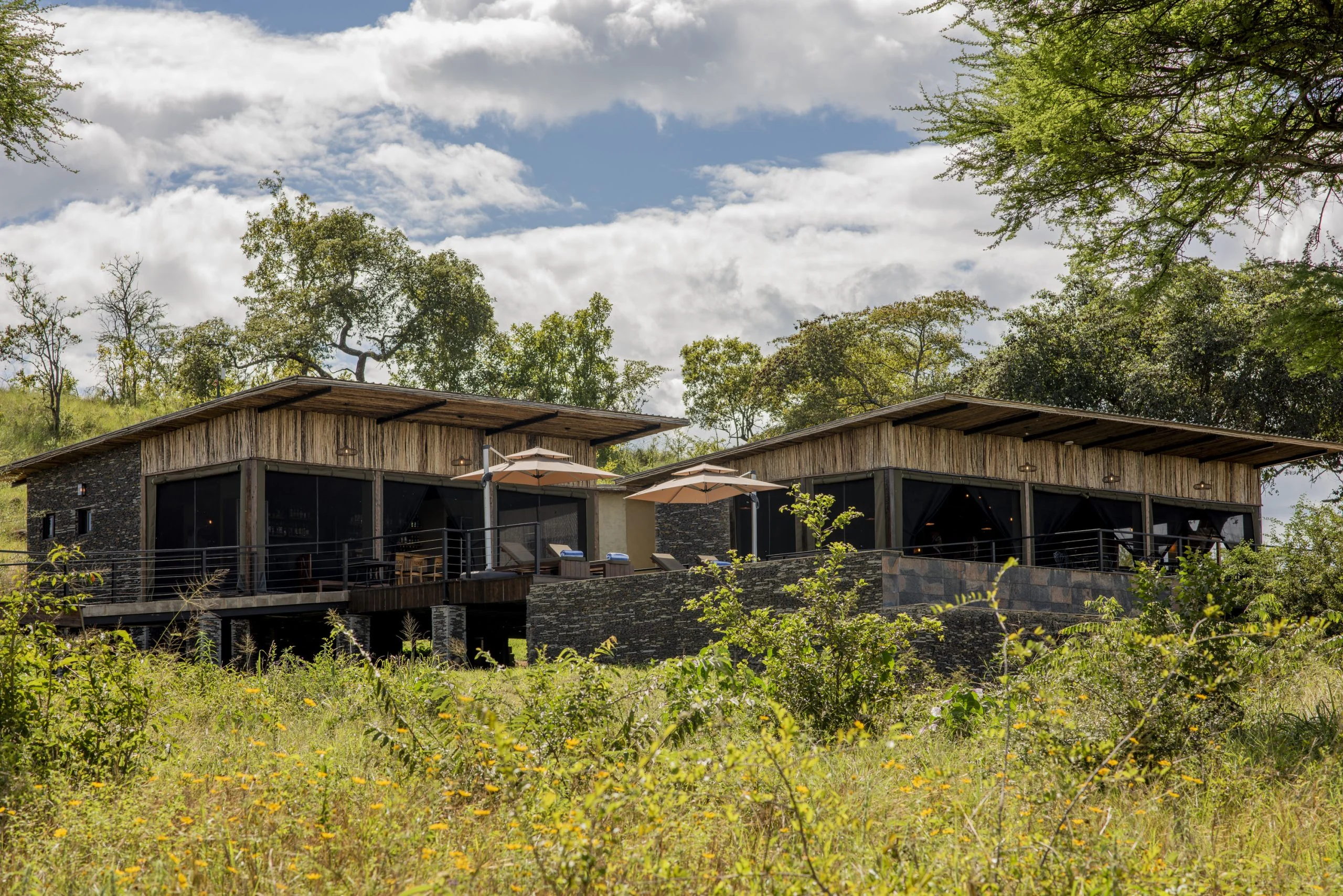 The lodge's stone and timber suites among the trees