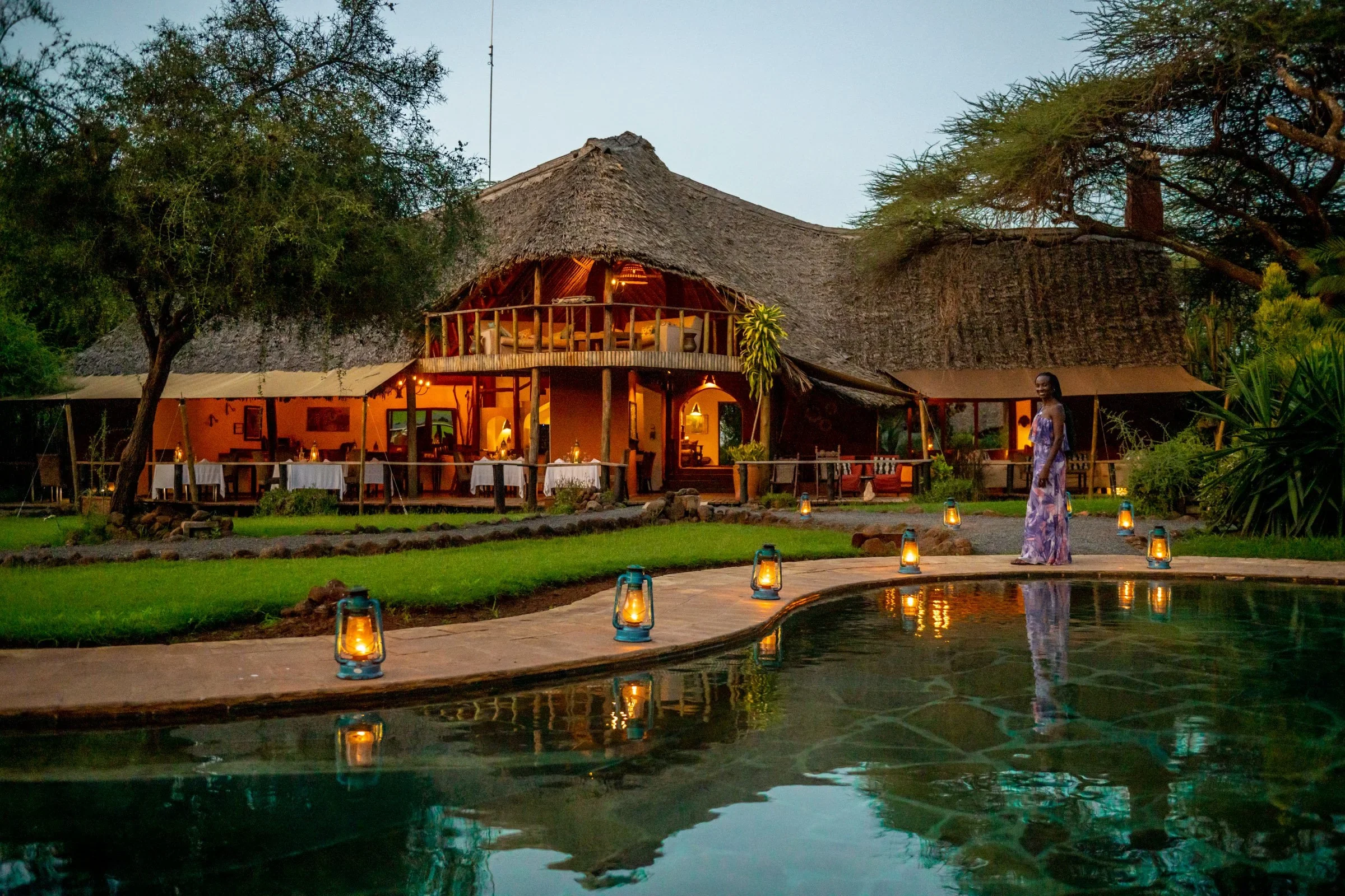 The lodge and its pool lit at dusk
