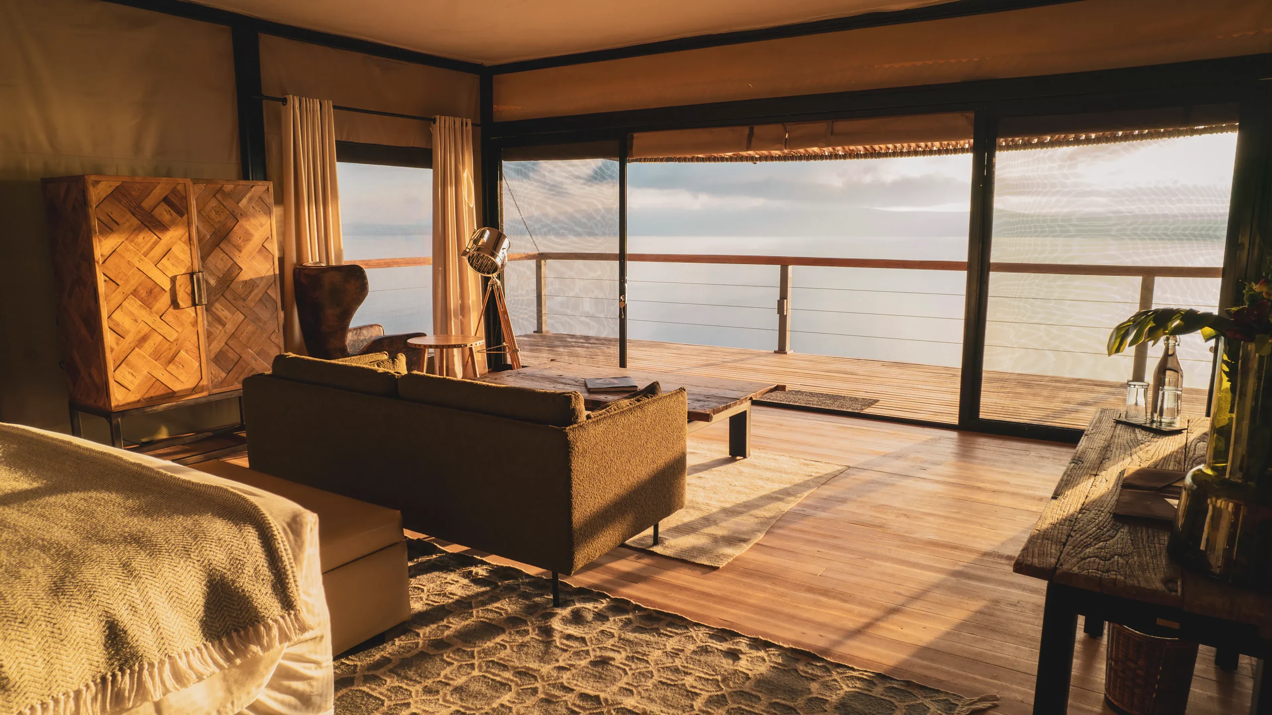 A tent lounge looking out over the lake