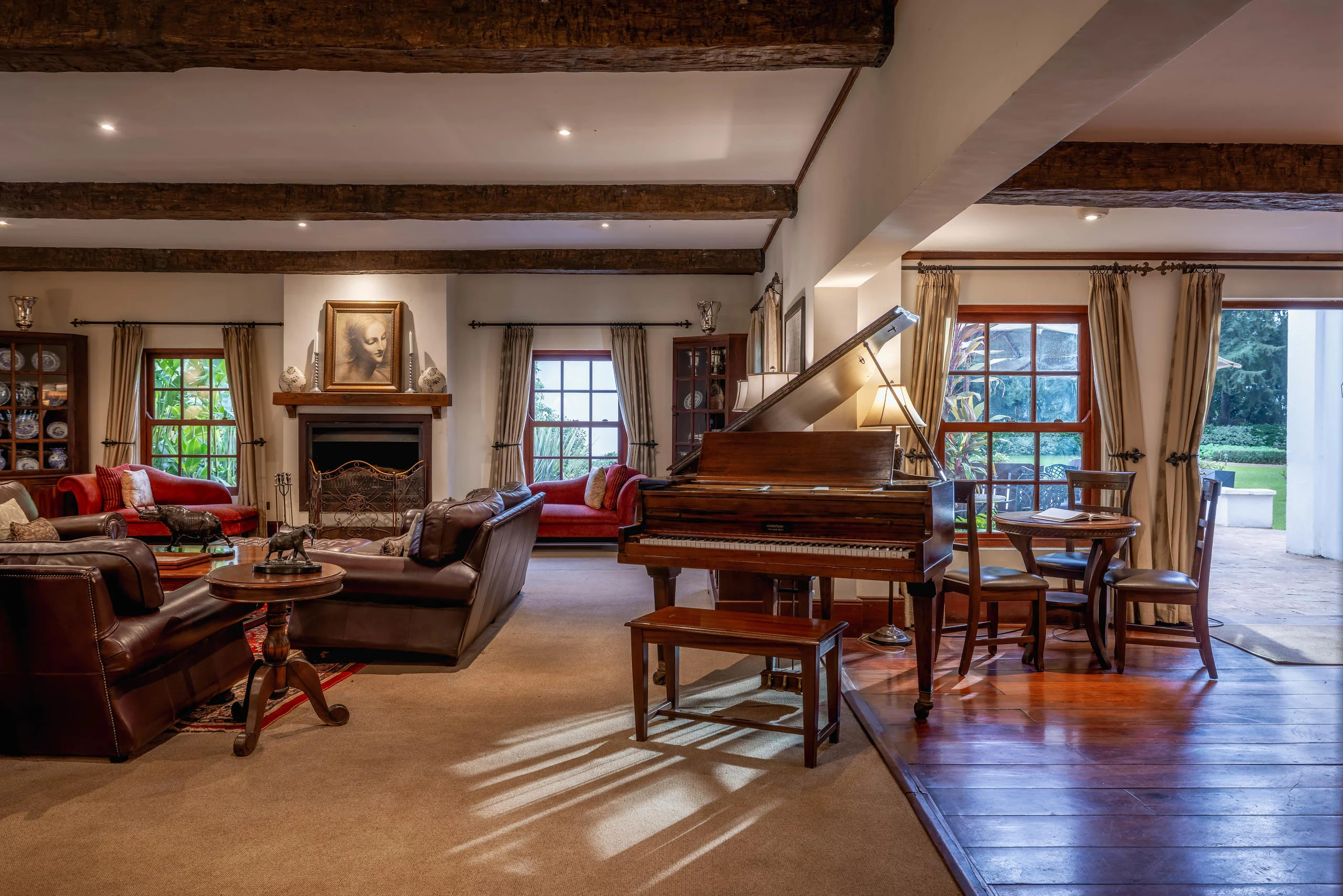 The lounge with a grand piano and leather armchairs
