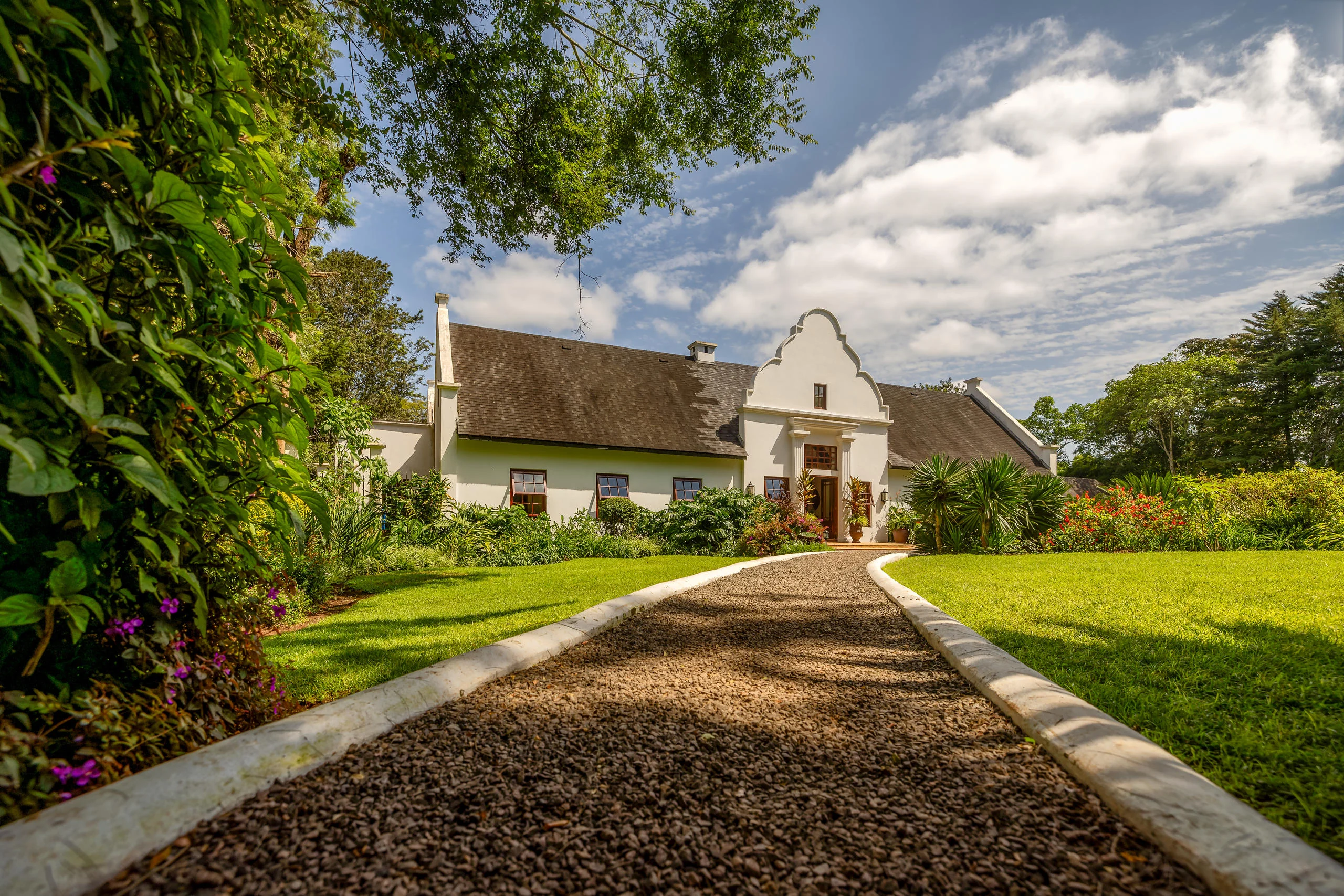 The gabled house at the end of a gravel path
