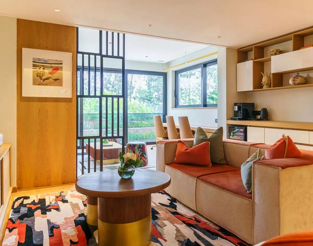 A suite sitting room with an orange sofa